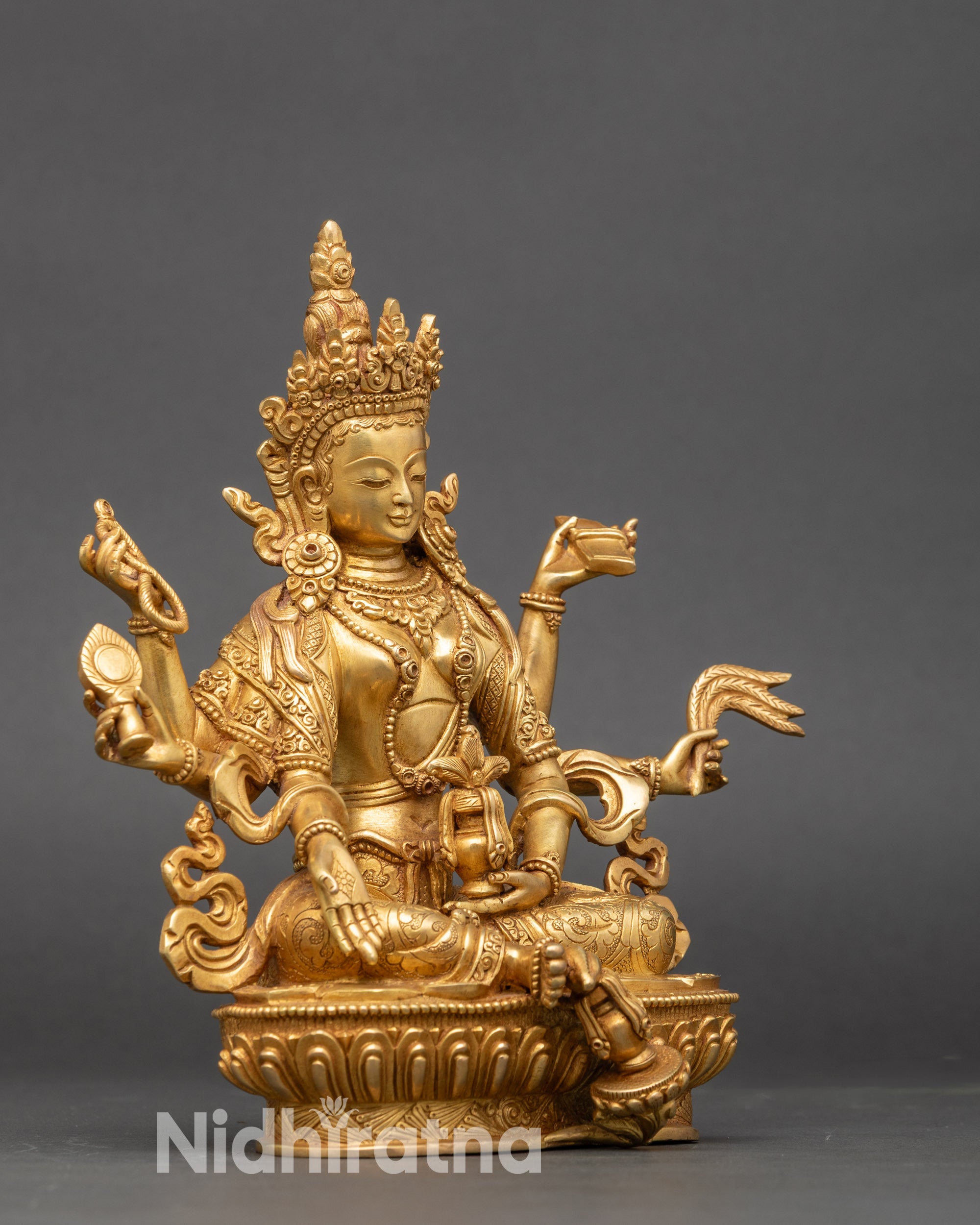 Himalayan Vasudhara statue holding treasure vase grain and manuscript gold gilded