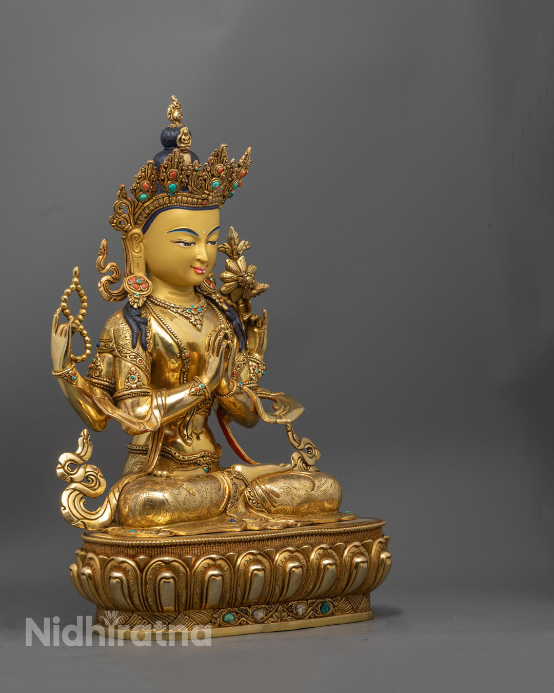 Intricate detailing of Chenrezig statue showing four arms, symbolic items, and expressive facial features crafted using the lost wax method.