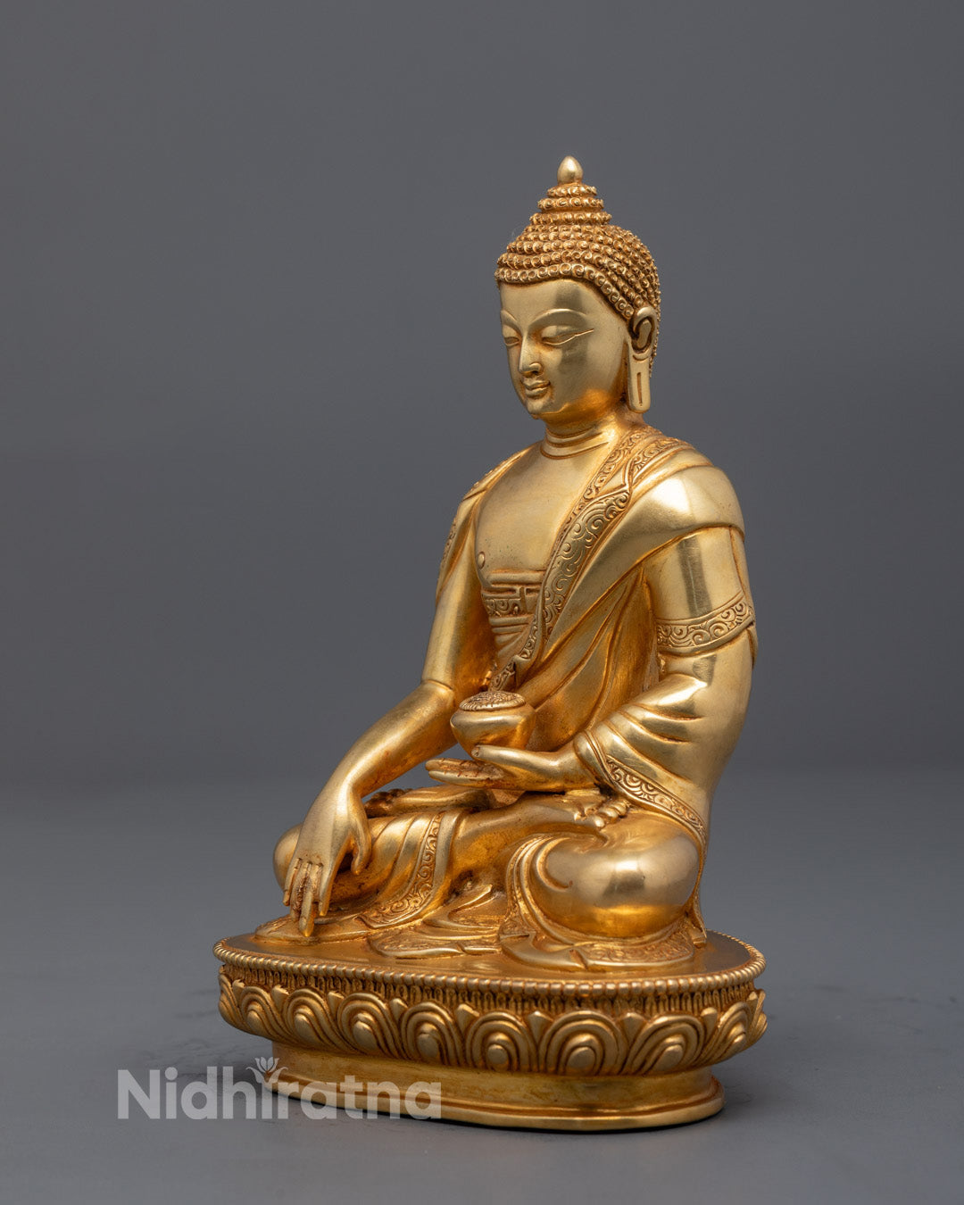 Intricately carved robe on Shakyamuni Buddha sculpture – highlights exceptional lost wax craftsmanship and vibrant acrylic artistry in a spiritual Tibetan statue.
