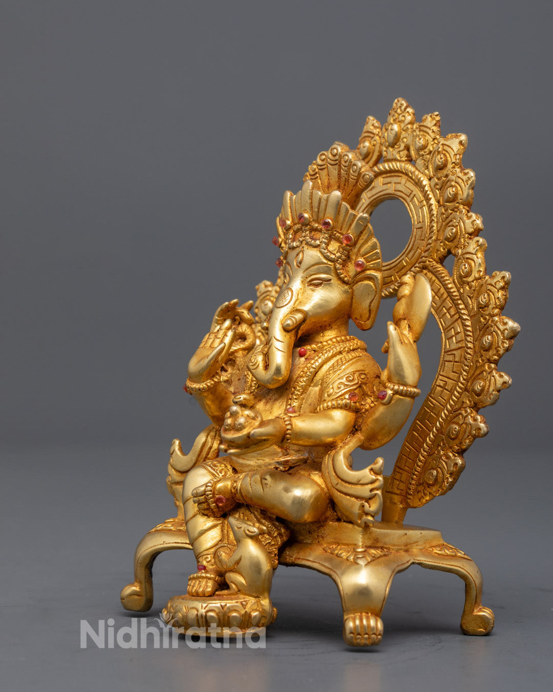 Intricately carved side view of Ganesha statue showing detailed crown, robe, and mouse symbol – handcrafted lost wax sculpture