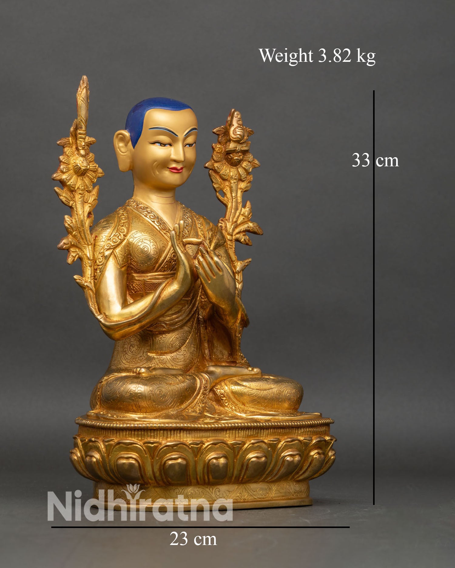 Right profile of Je Tsongkhapa statue with sword and Prajnaparamita book on lotus stems