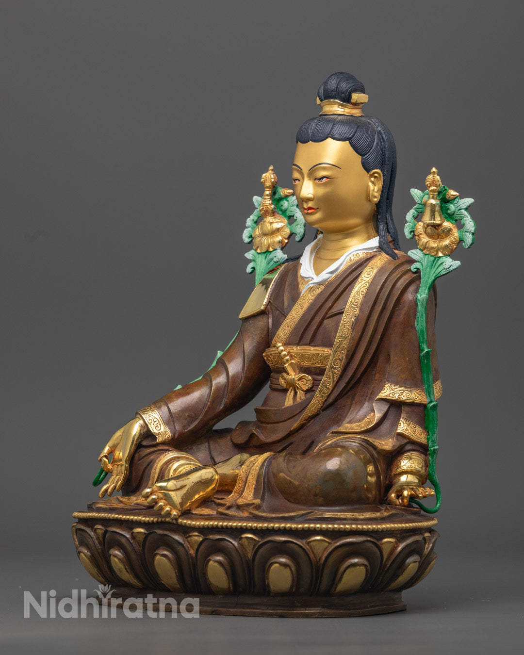 Jigme Lingpa statue holding an Utpala flower, symbolizing pure wisdom in Tibetan Buddhist art.