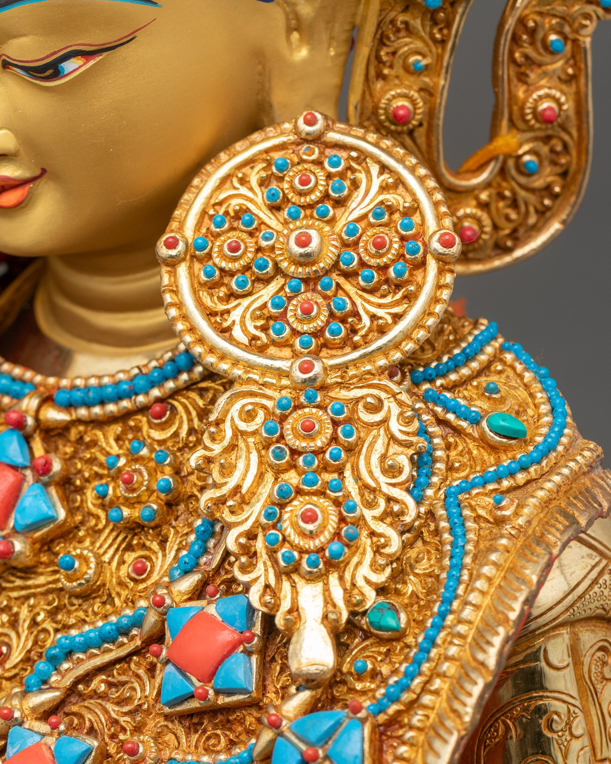 Detailed close-up of ornate earrings on Jowo Shakyamuni Rinpoche Statue, showcasing fine Newari craftsmanship
