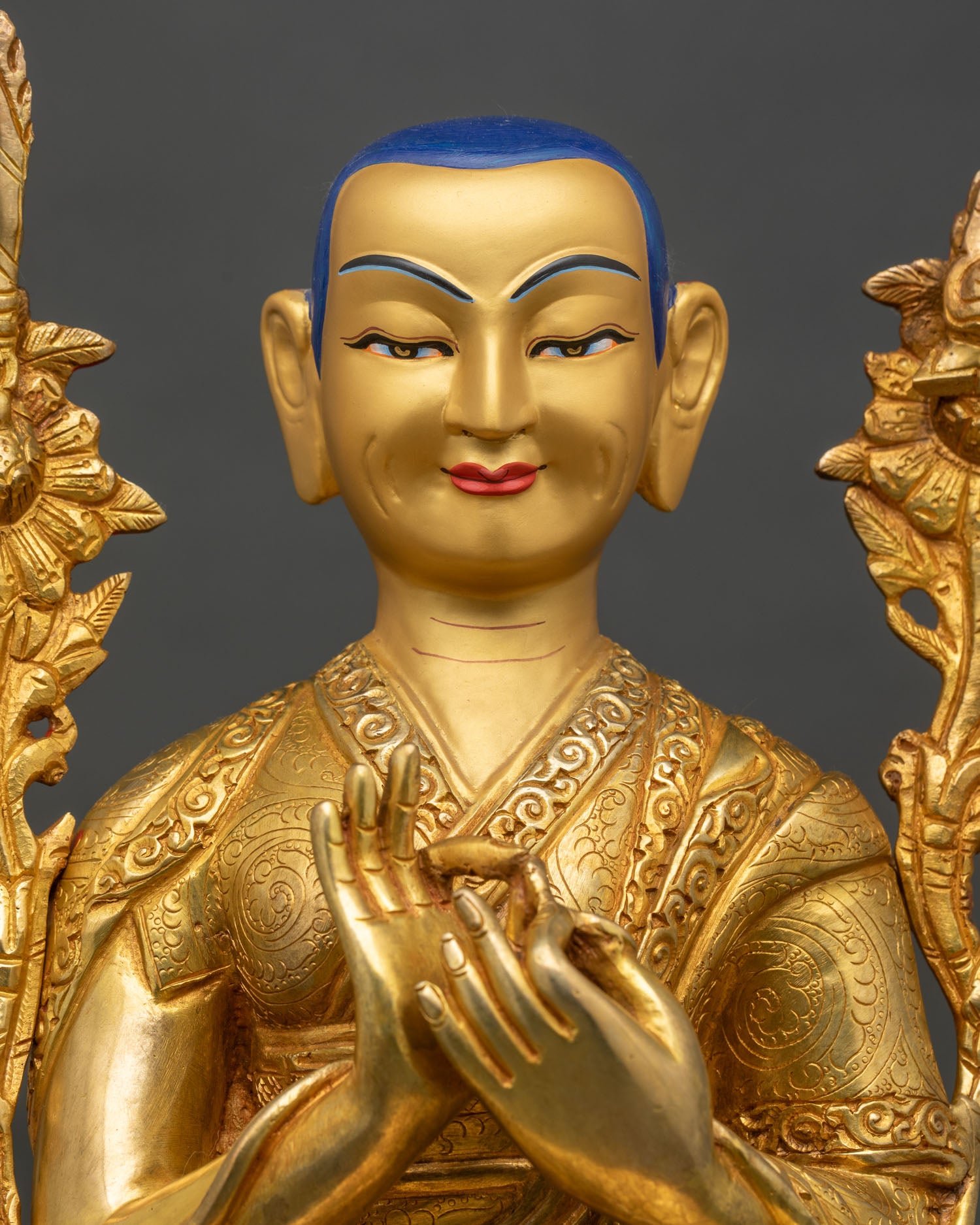 Close-up of Lama Tsongkhapa statue showing copper body and gold painted details