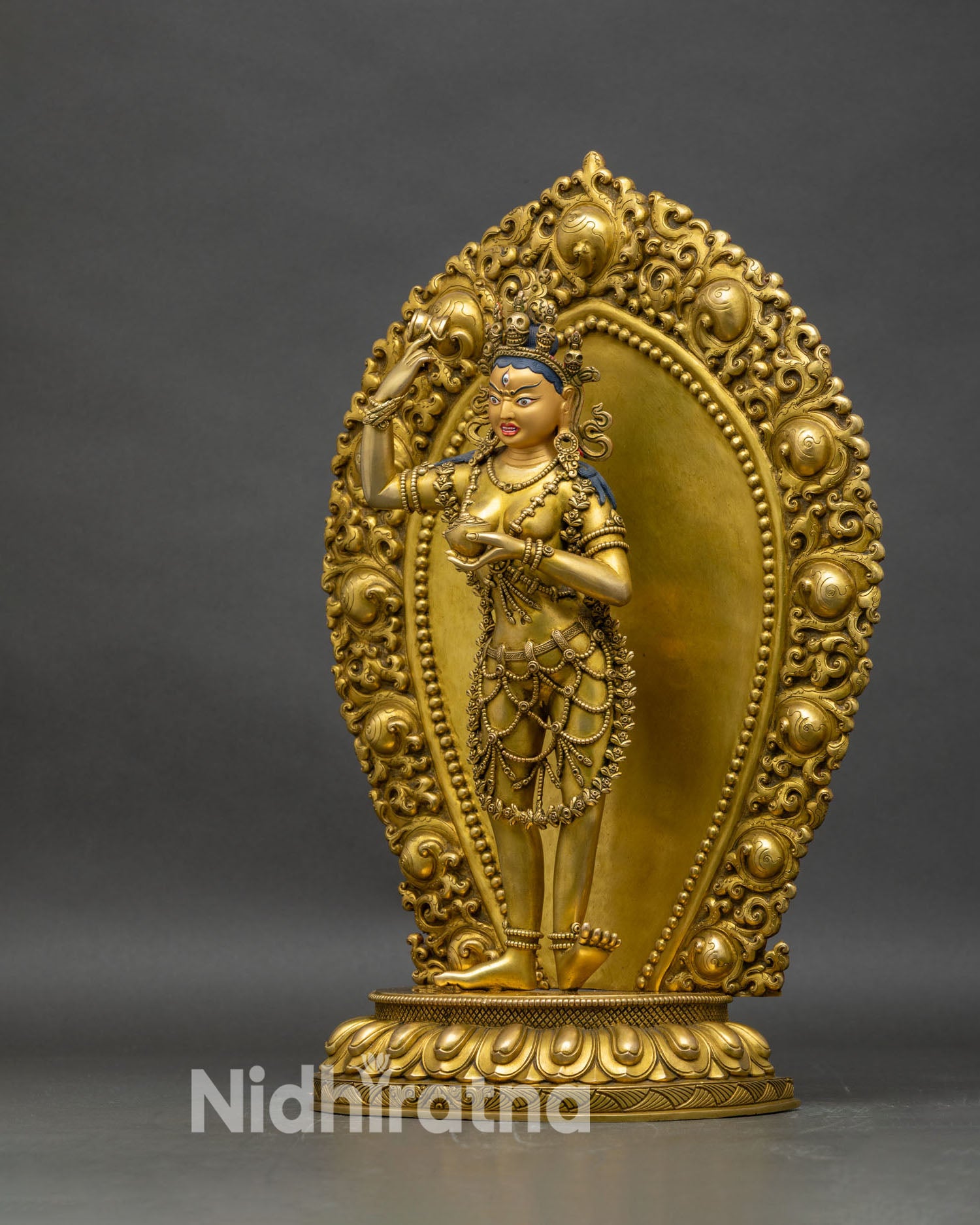 Left profile of Achi Chokyi Drolma statue, copper and gold with prabhavali halo