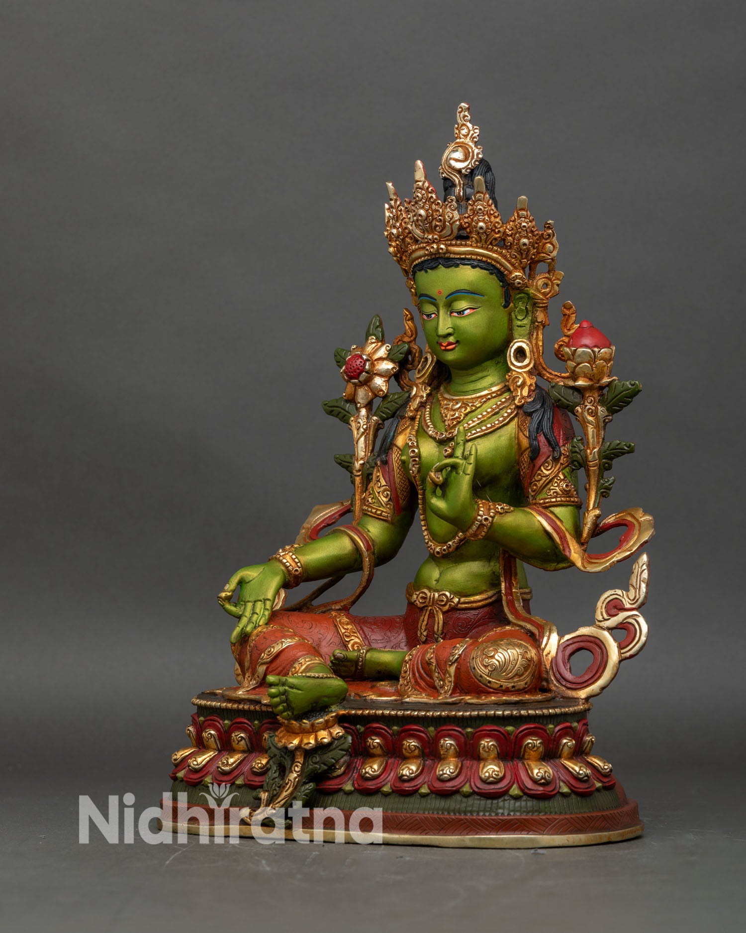 Left profile of Green Tara statue, detailed lotus seat and gold embellishments