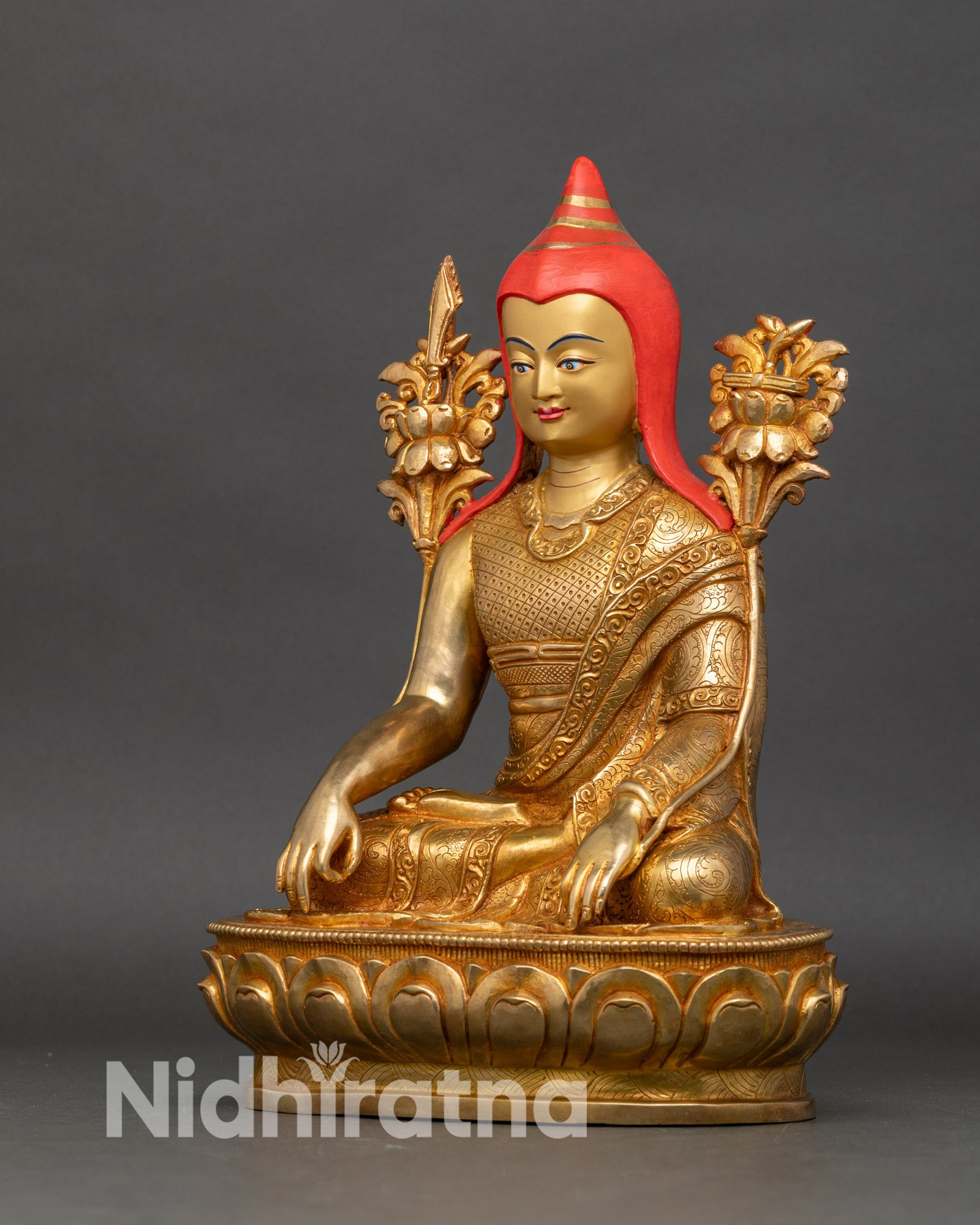 Left side view of Longchenpa statue, showing intricate robe and flower details