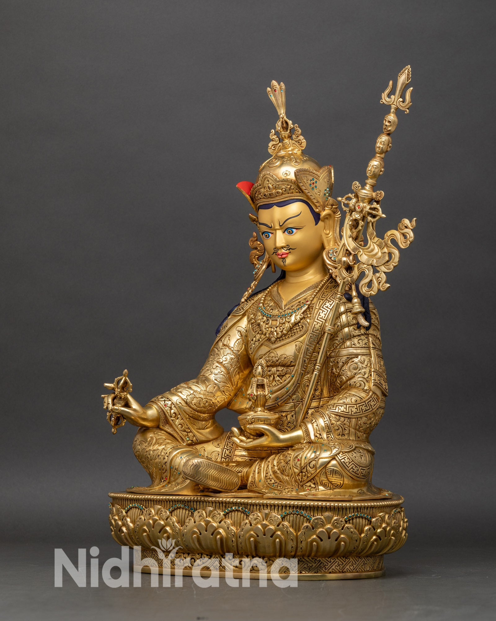 Left side view of Guru Rinpoche statue, fire-gilded copper, Vajra, Kapala, Khatvanga