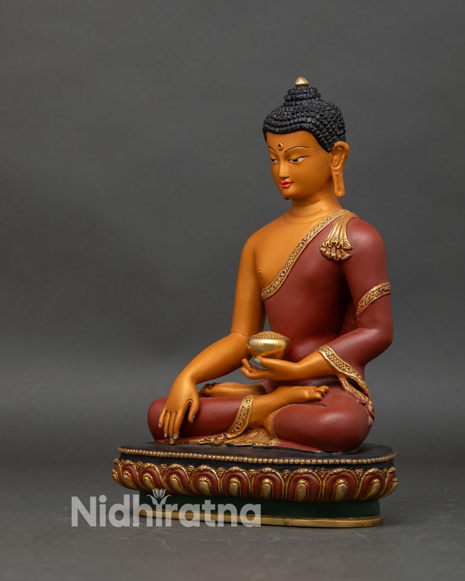 Left side view of Shakyamuni Buddha statue, solid copper with gold-gilded lotus base