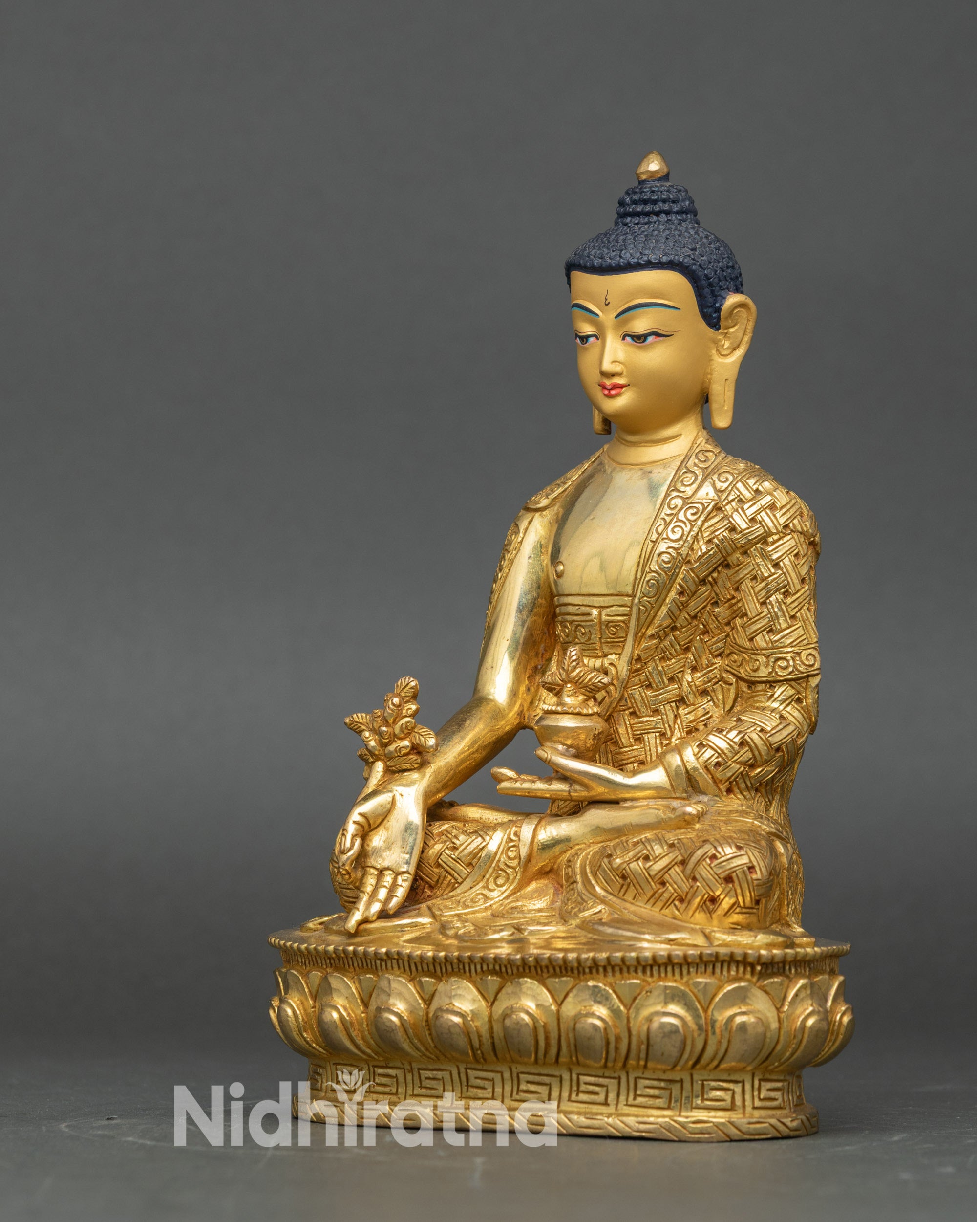 Left-side view of Medicine Buddha statue, gold fire-gilded copper with intricate lotus throne