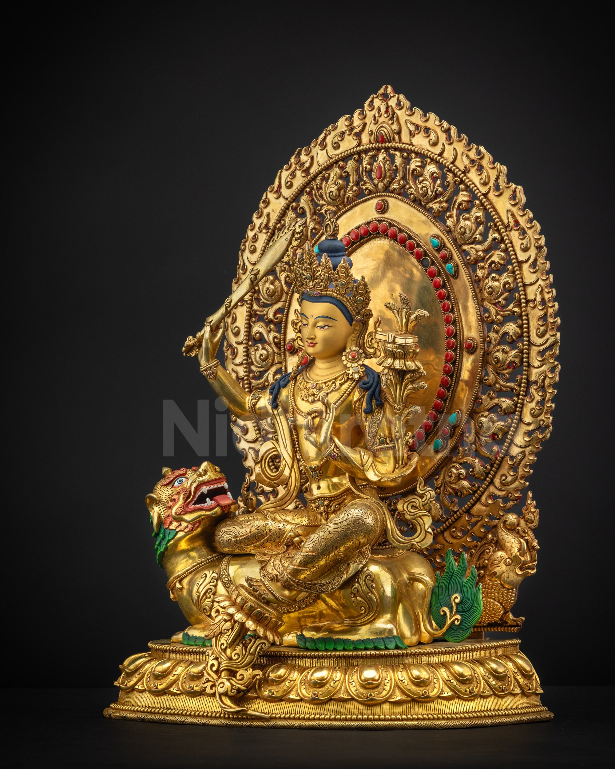Left-side view of lion-seated Manjushri sculpture with gold fire-gilded carvings and symbolism