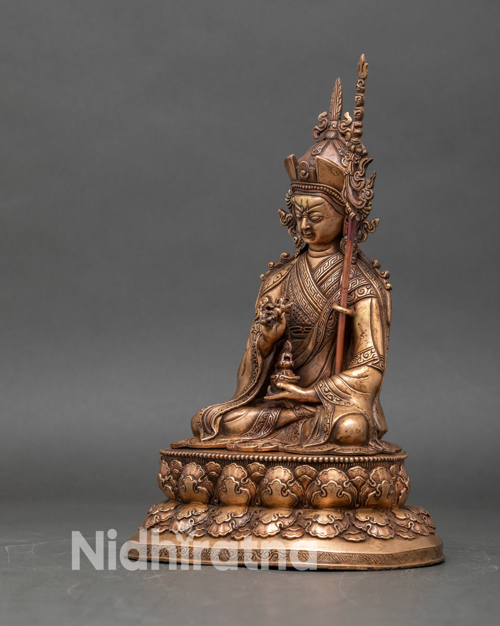 Left side view of Guru Tsokye Dorje statue with Vajra and ritual implements in hands