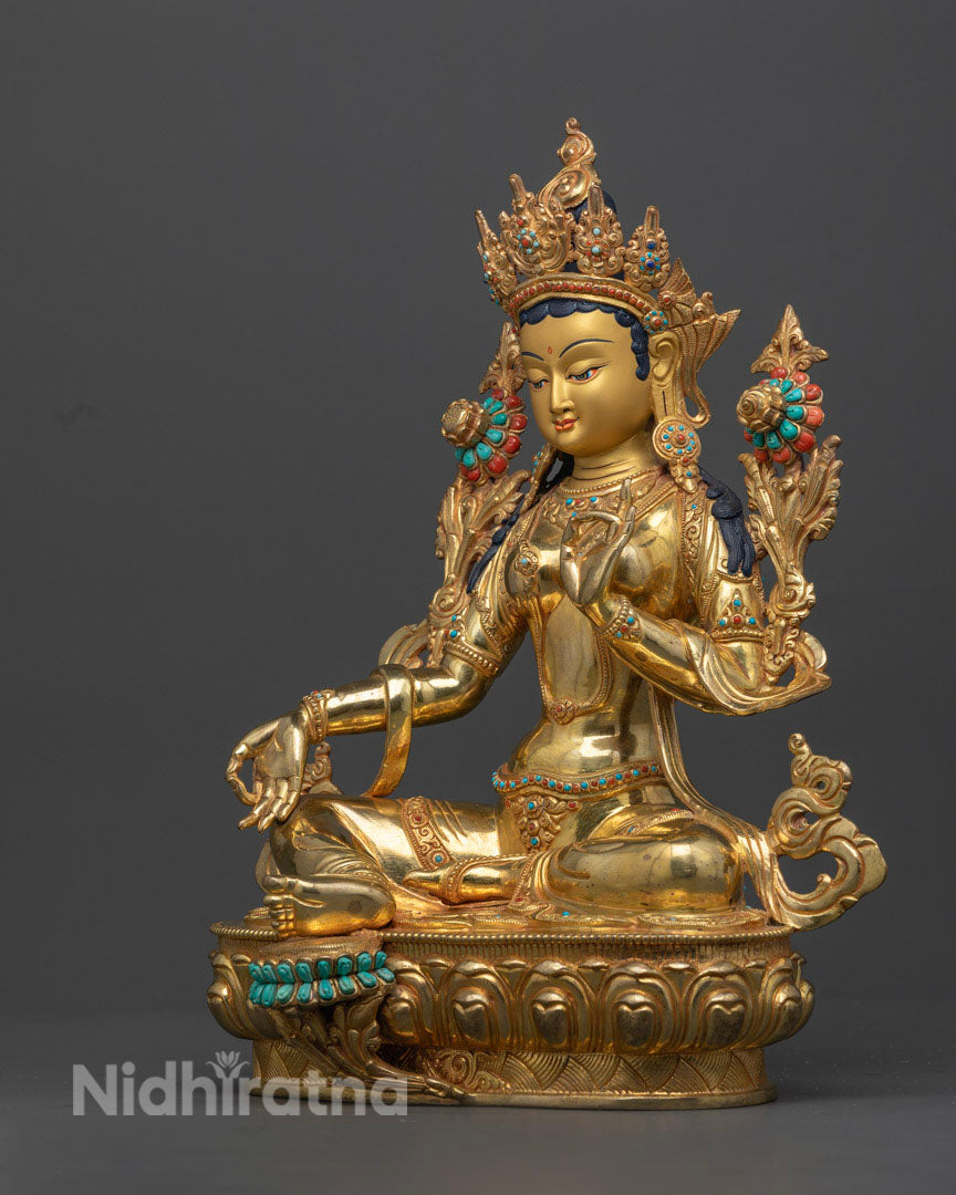 Highlighting right view of green tara statue with Vitarka mudra and in a royal posture