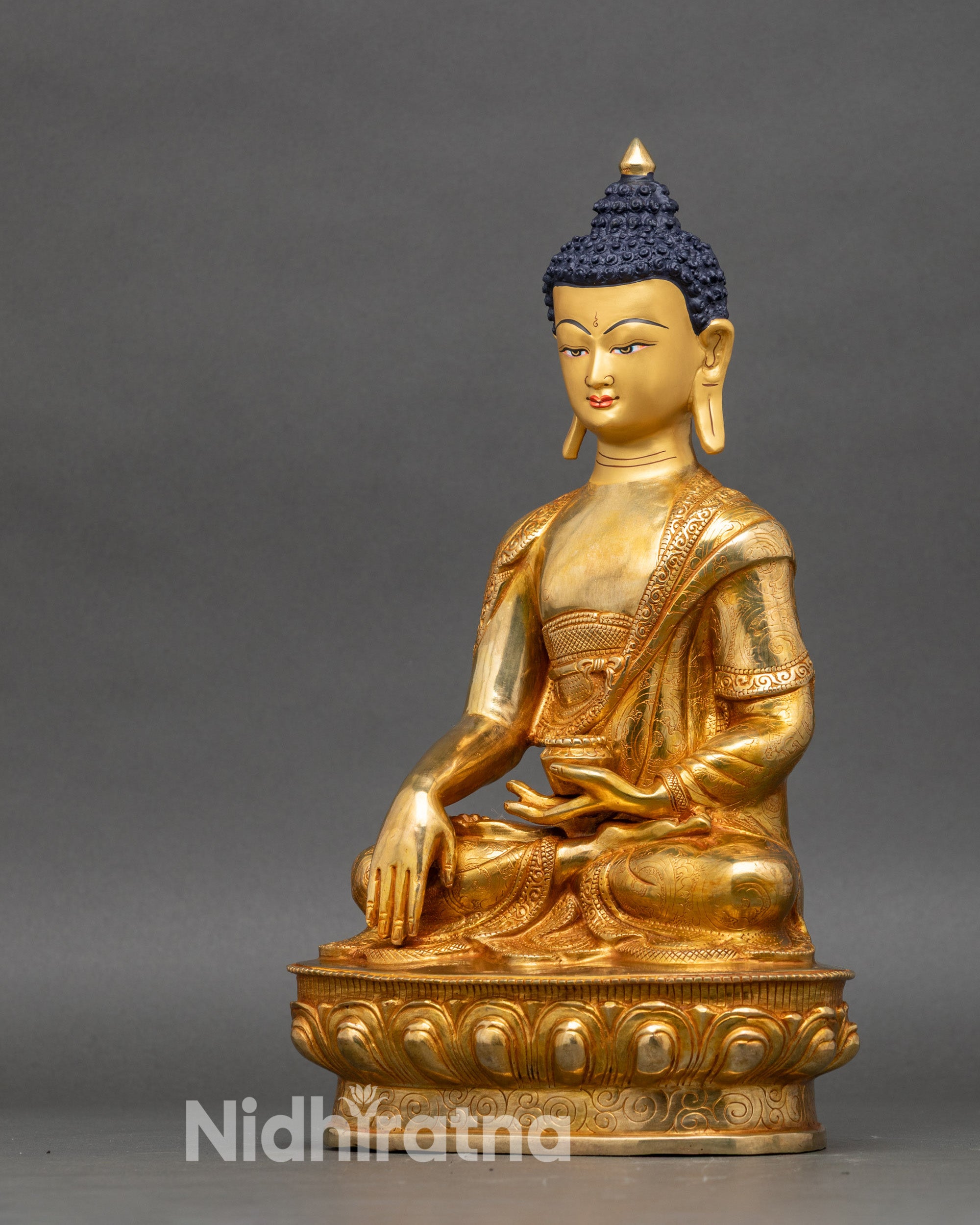 Left profile of Shakyamuni Buddha copper figurine with detailed monk robe texture
