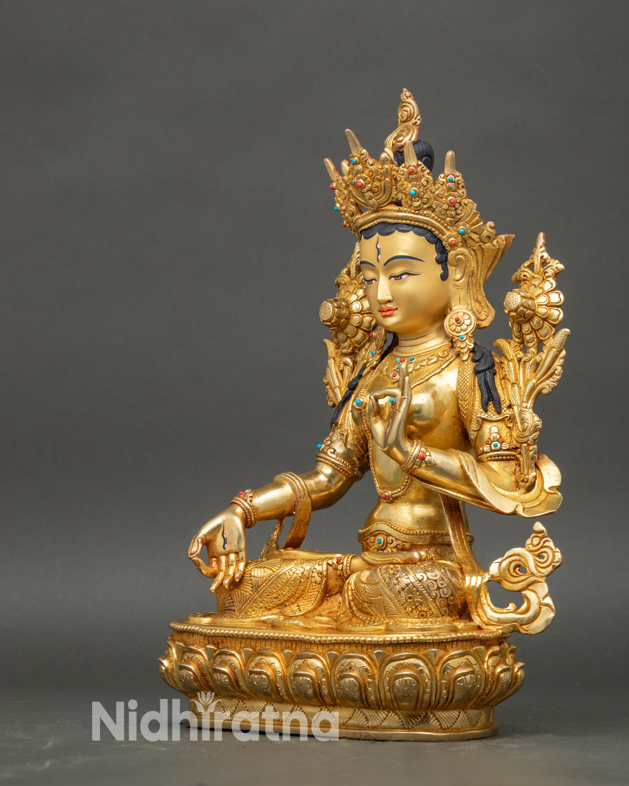Left profile of White Tara statue, detailed gold fire-gilded copper sculpture