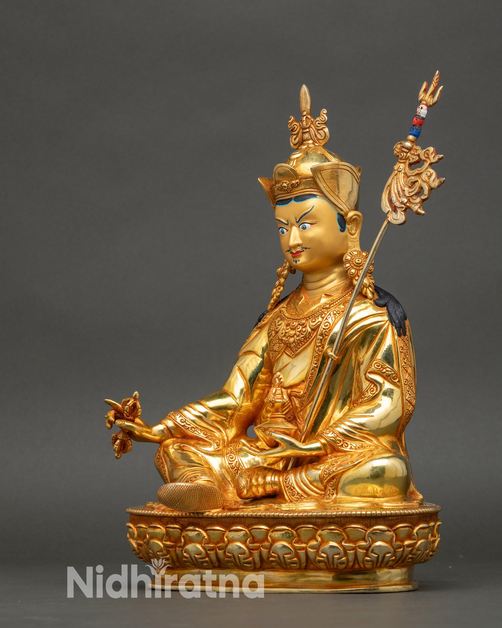 Left profile showing intricate motif patterns on Guru Rinpoche’s garments and lotus seat