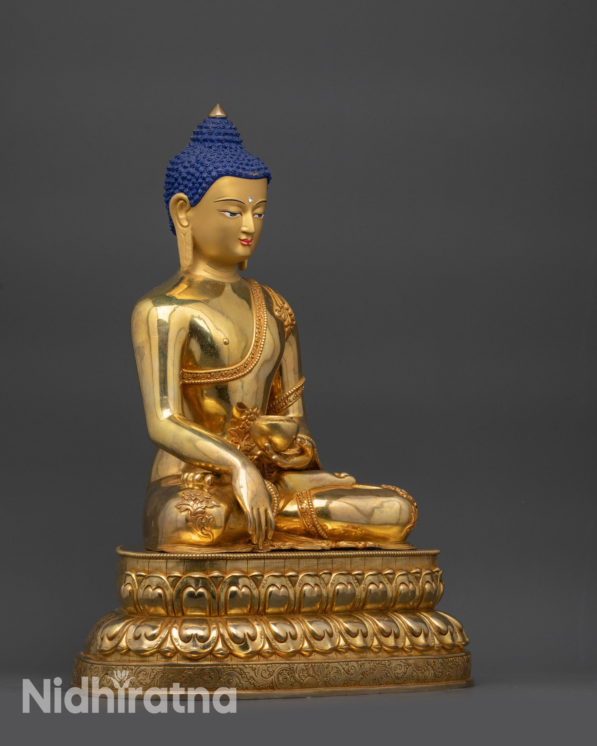 Left side Shakyamuni Buddha Statue displaying flowing robes and patterned garments