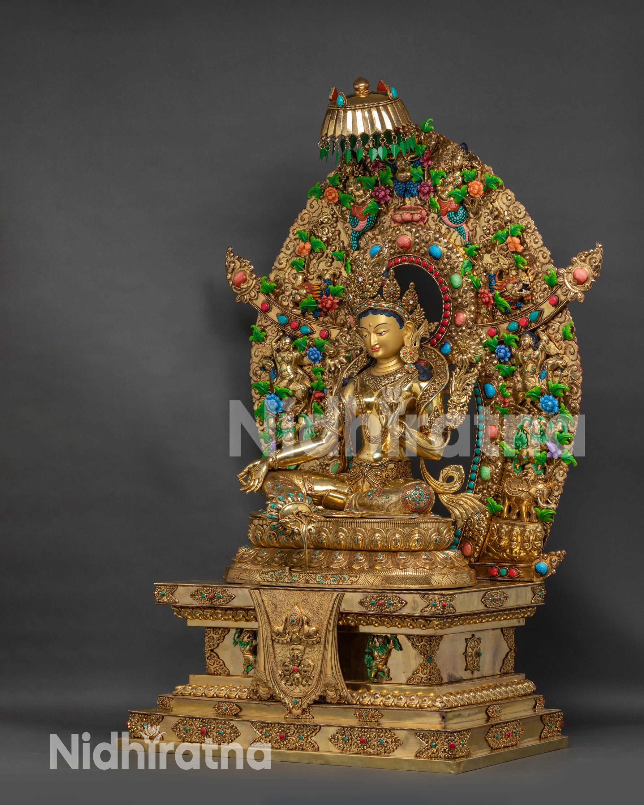 Left side view Nepalese Green Tara Statue with lotus seat and decorative halo