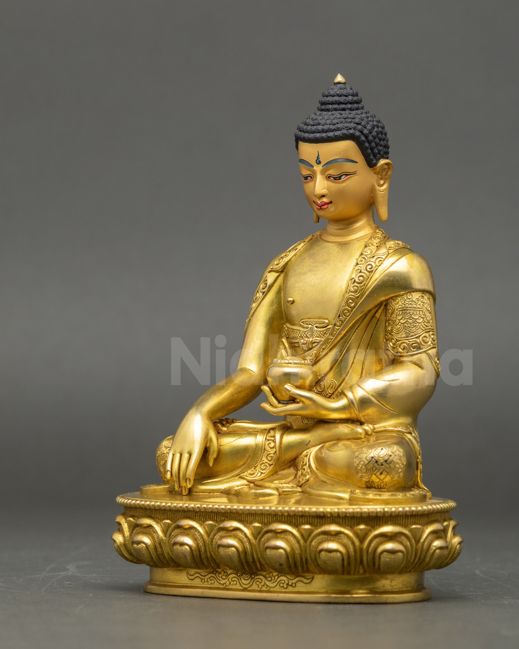 Left side view of Buddha Shakyamuni Statue highlighting gold-painted face and sacred details