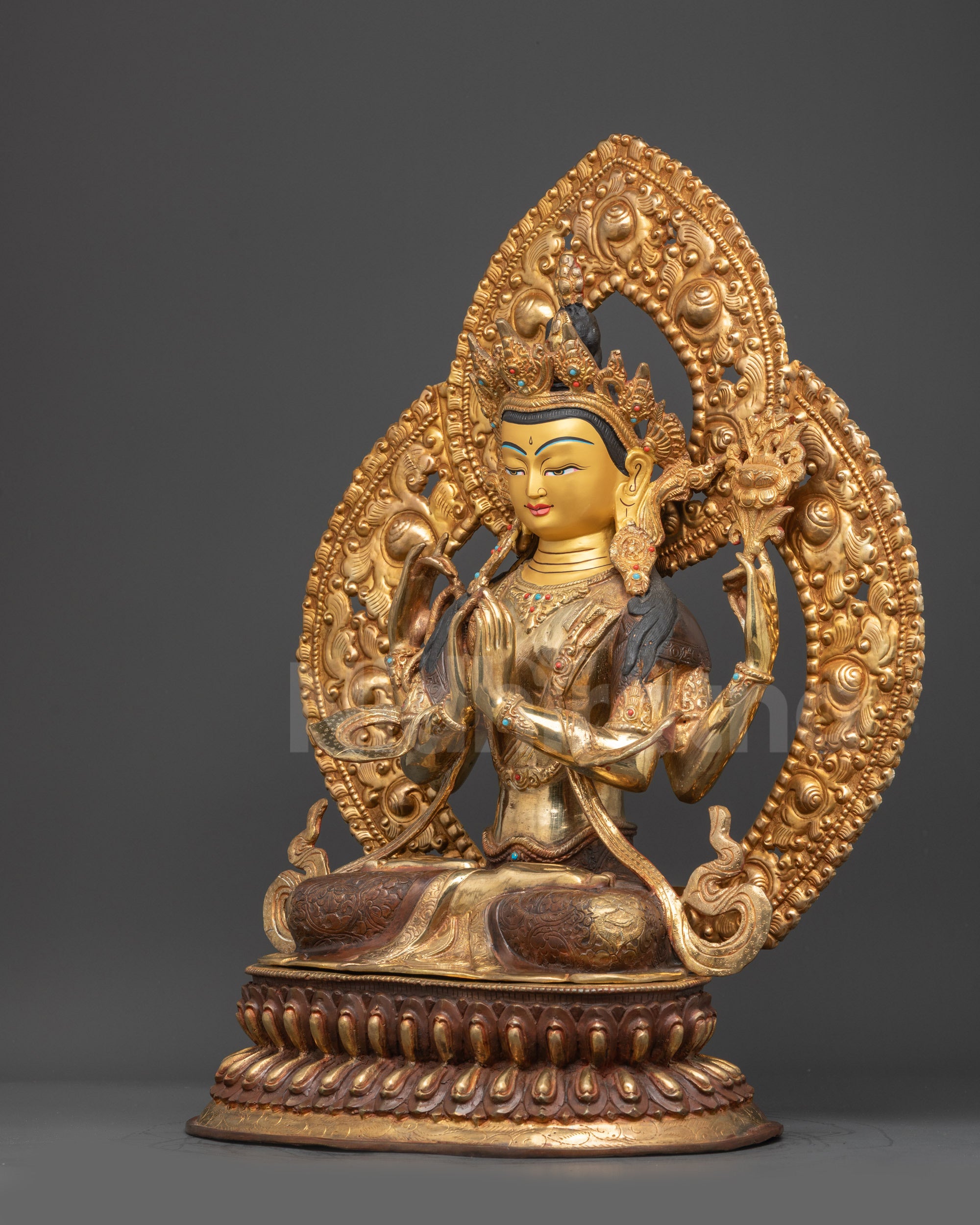 Left side view of Chenrezig Statue showing four arms and partially gold fire-gilded base