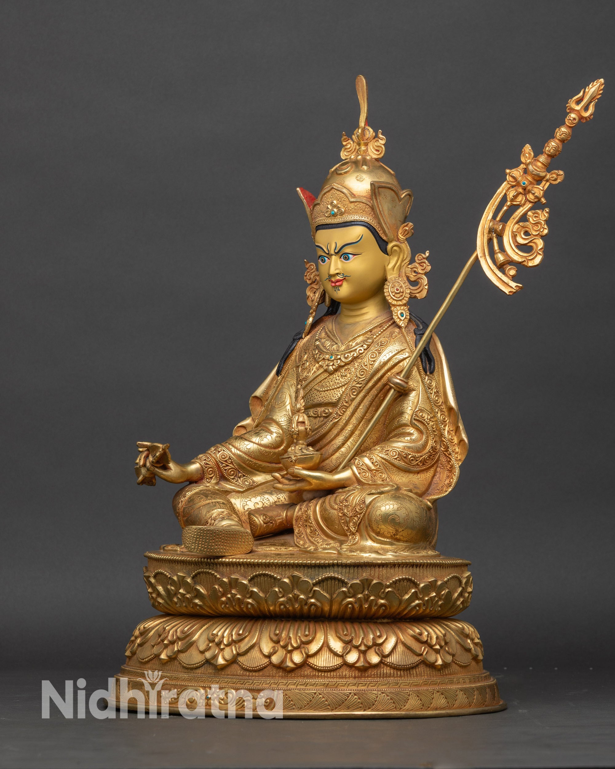 Left side view of Guru Rinpoche statue – gold-gilded Guru Rinpoche statue seated on double-layered lotus pedestal