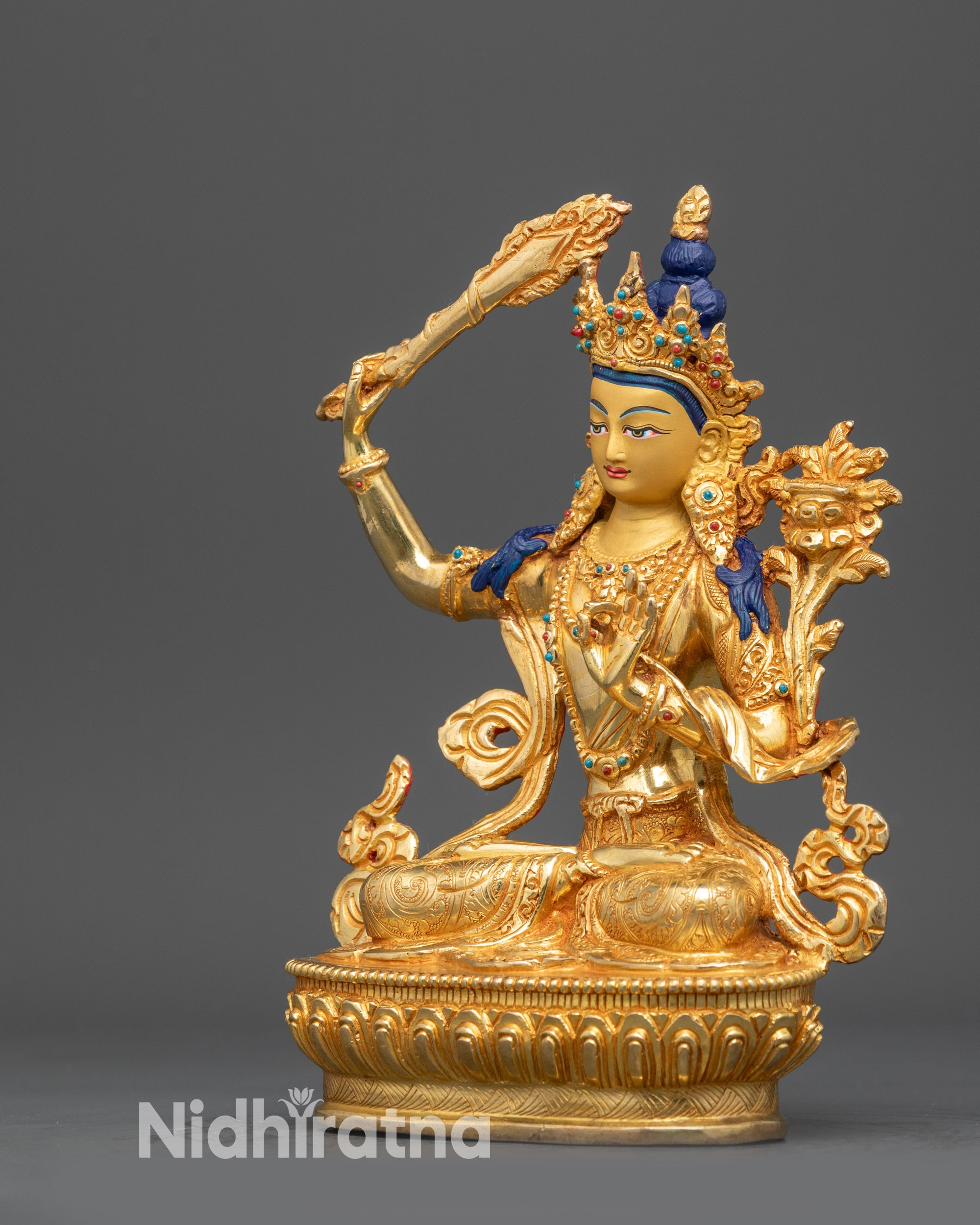 Left side view of Manjushri statue showing intricate robe details