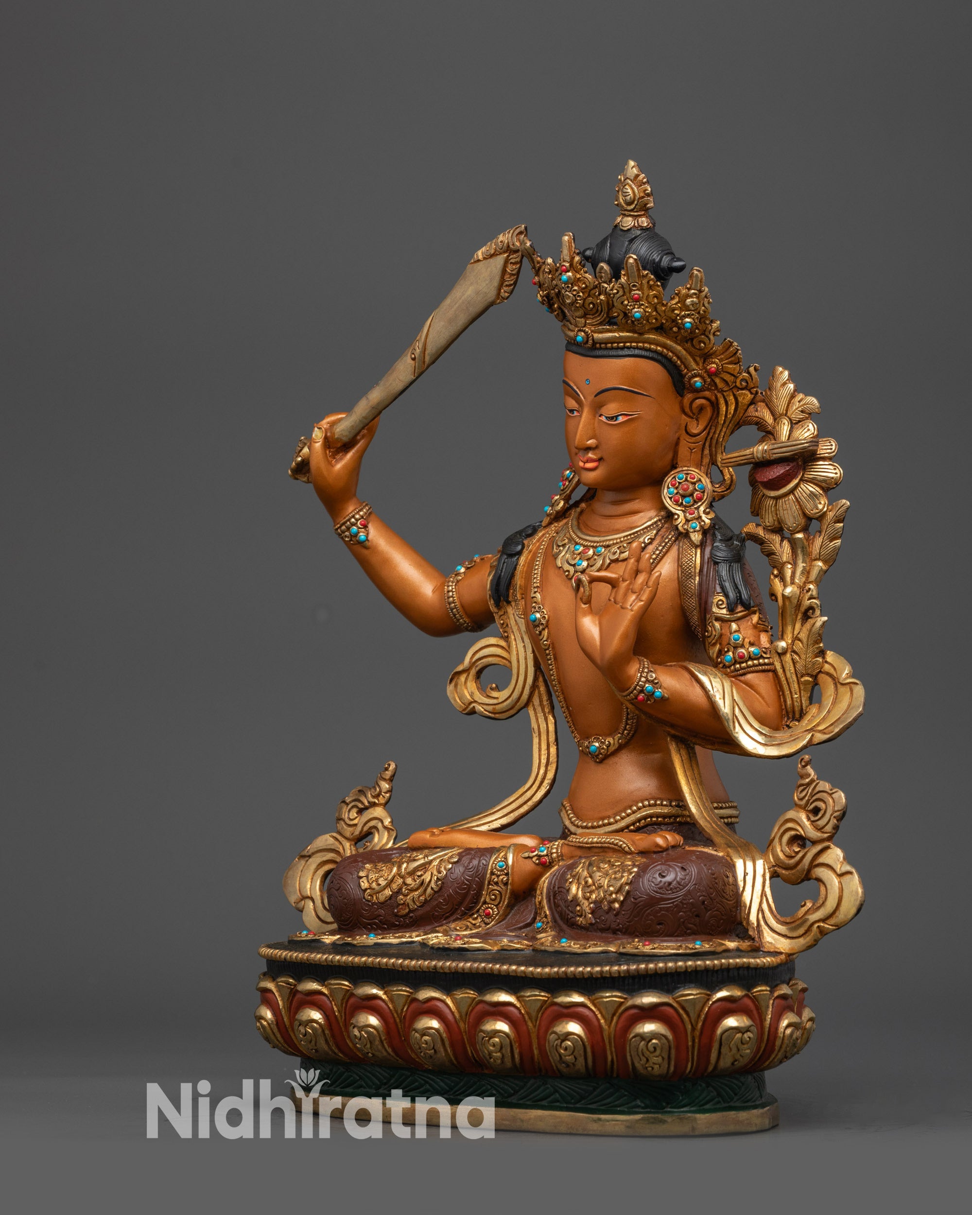 Left side view of Nepalese Manjushri statue with gold lotus seat and robe details