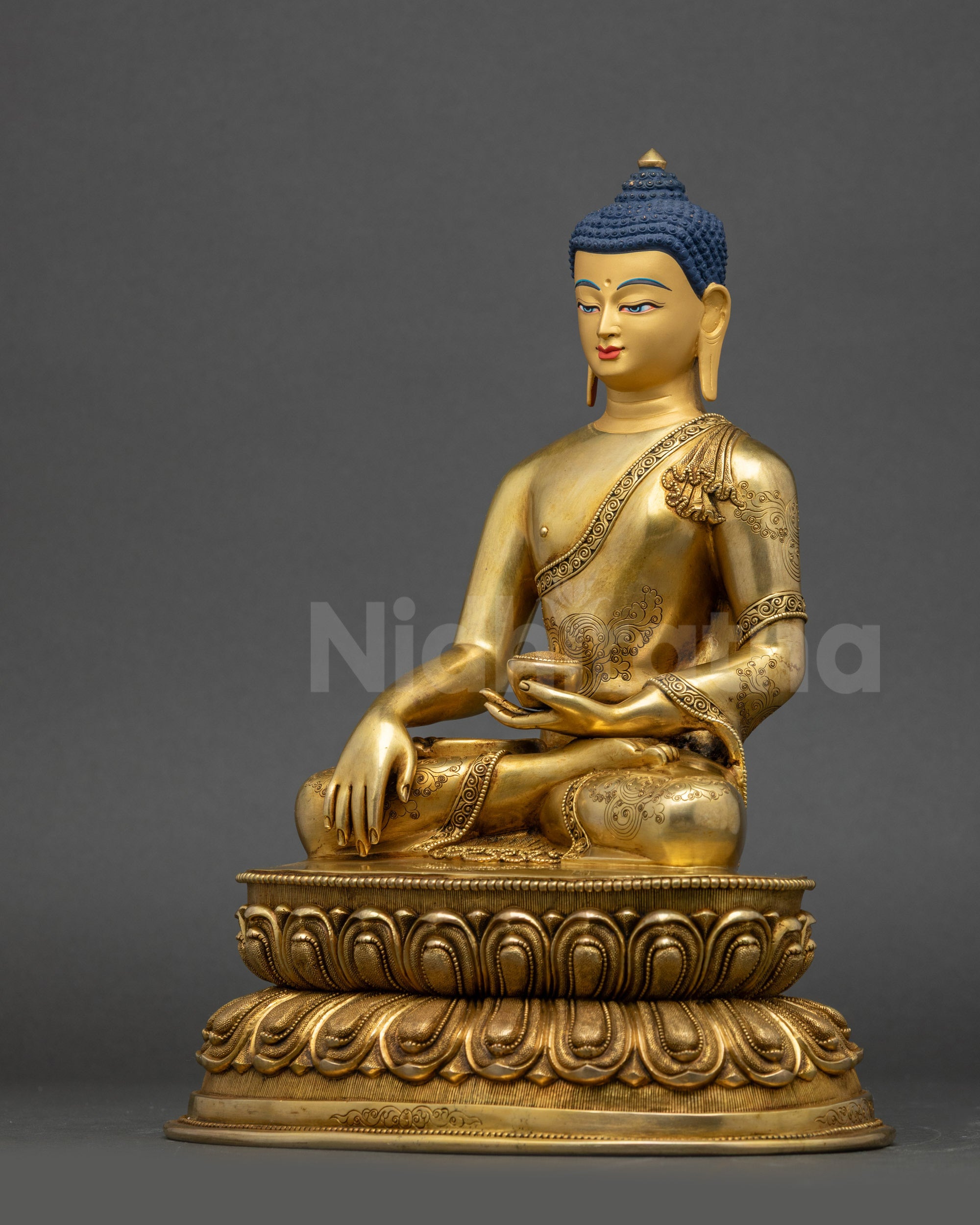 Left side view of Shakyamuni Buddha statue displaying symbolic robe details and posture