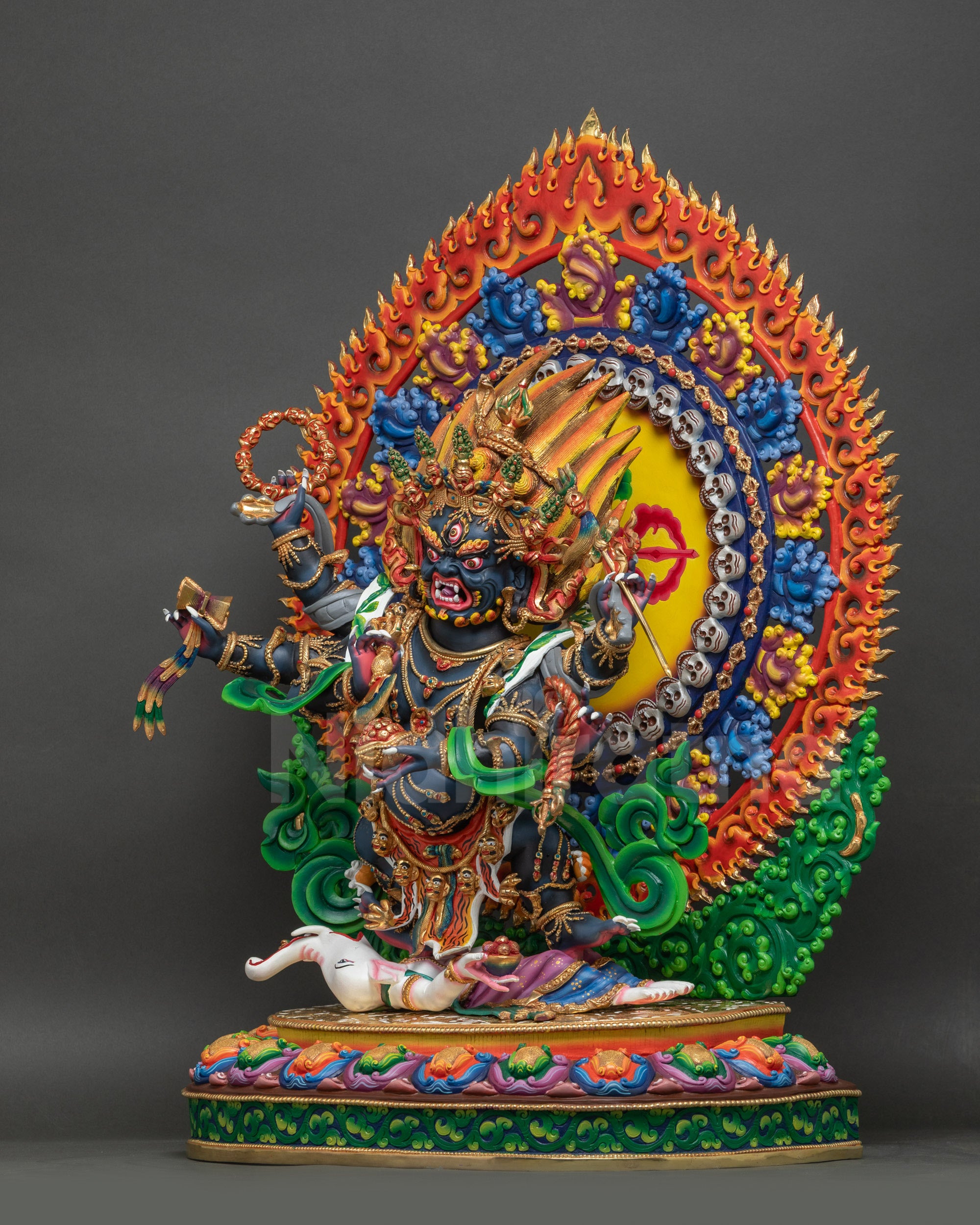 Left side view of Six-Armed Mahakala Statue with Kartika knife, Kapala, and lotus seat details
