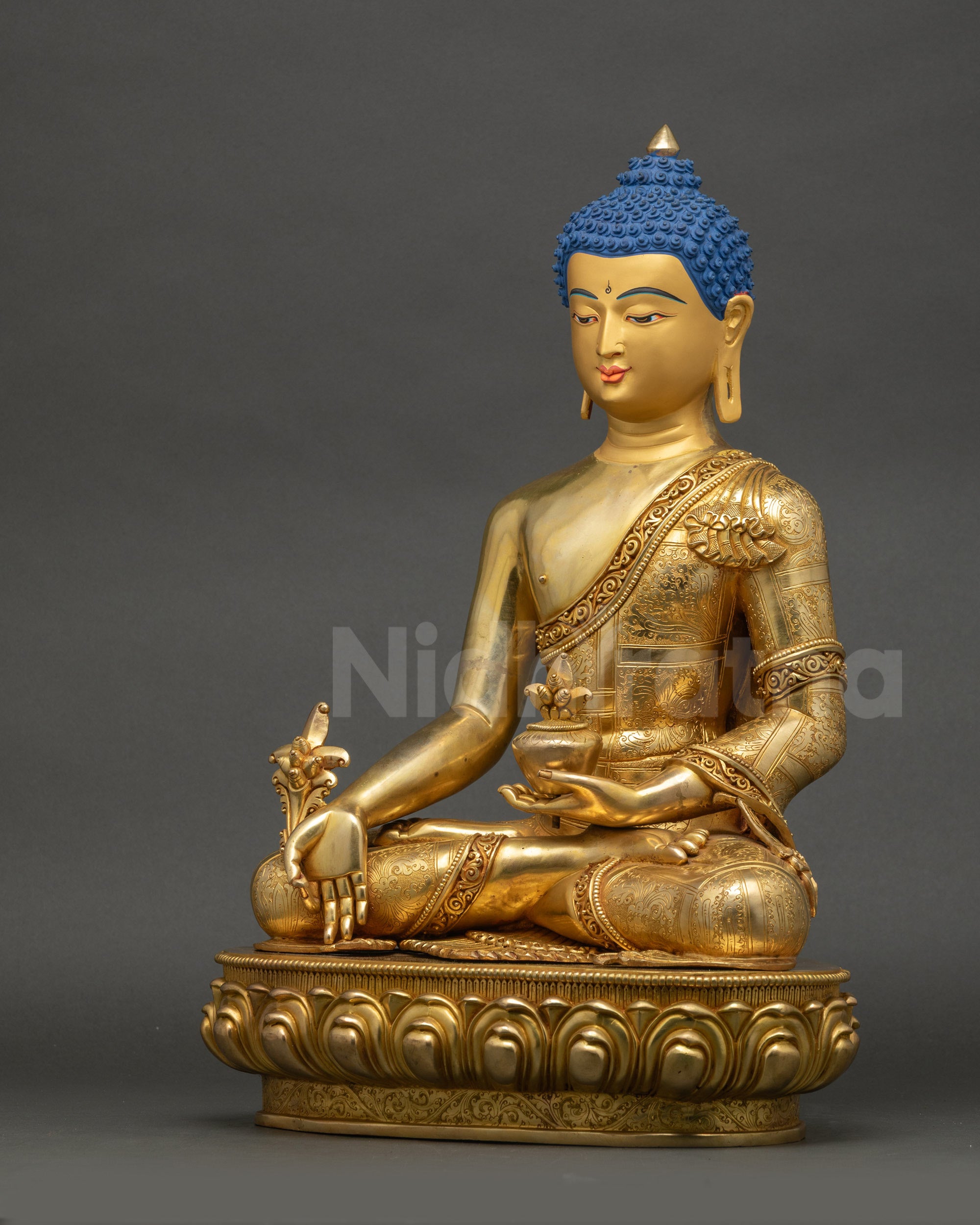 Left side view of gold Medicine Buddha statue showing intricate robe and halo
