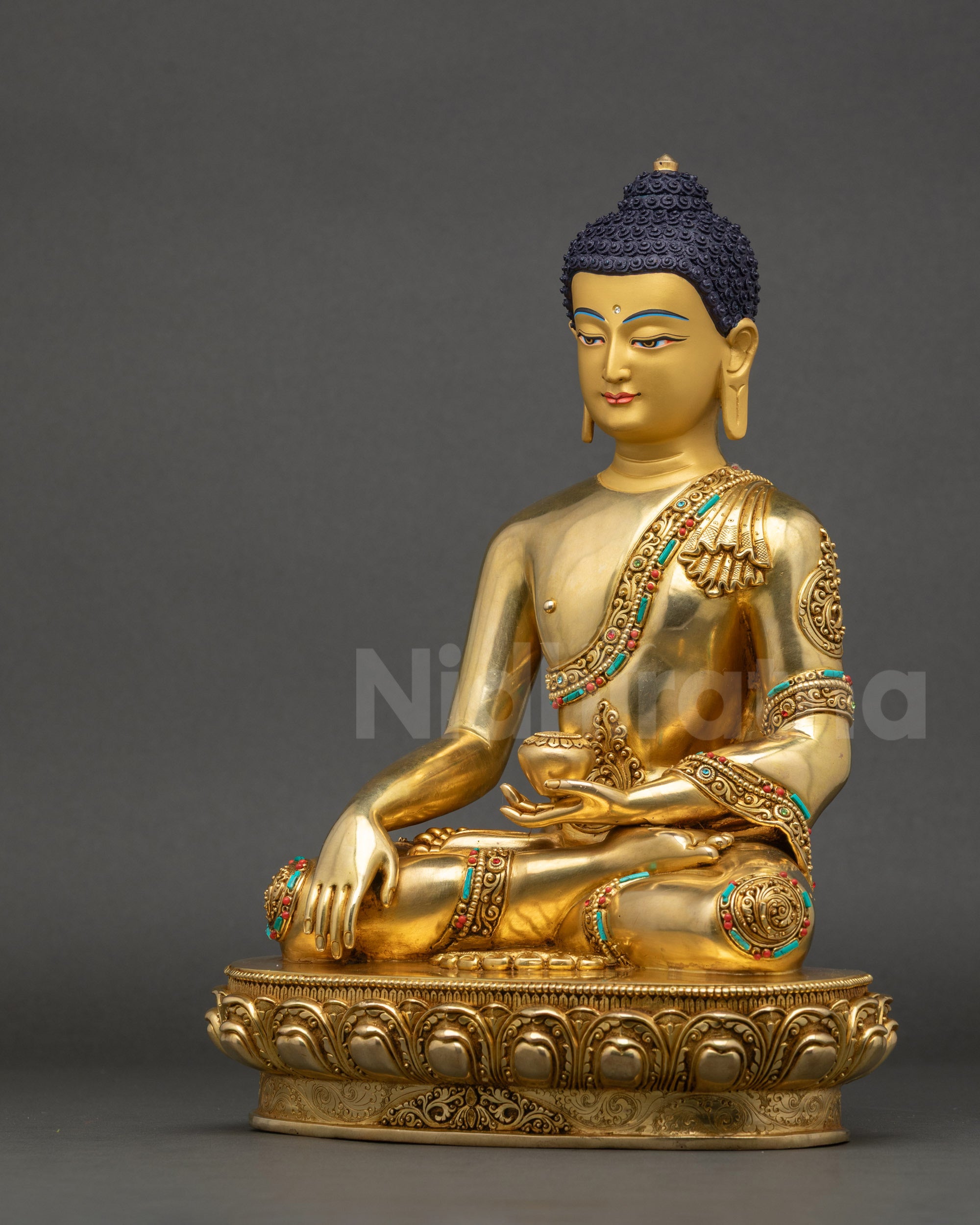 Left-side view of Shakyamuni Buddha showing floral motif robe and lotus base