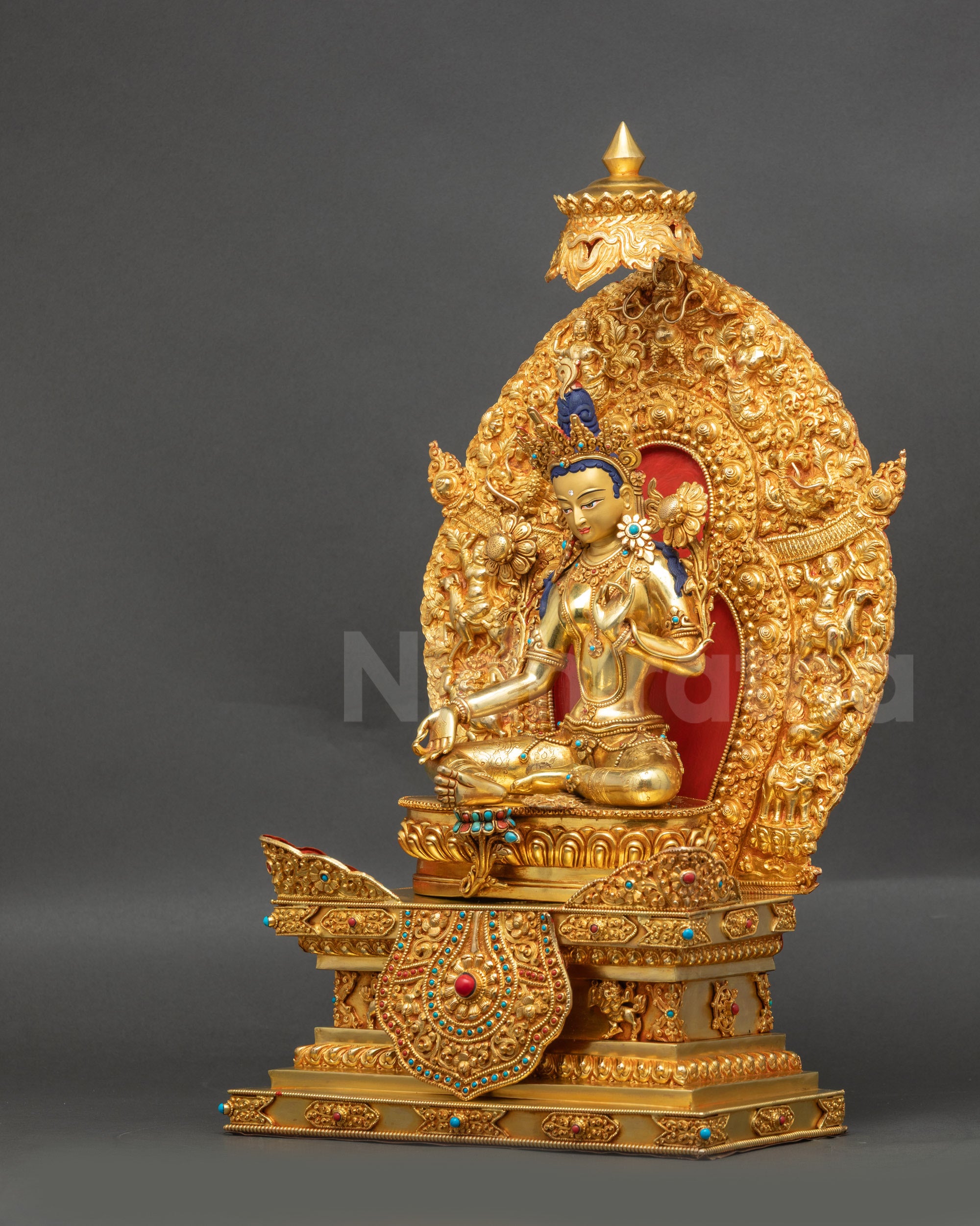 Left view of Green Tara statue with lotus throne for meditation space