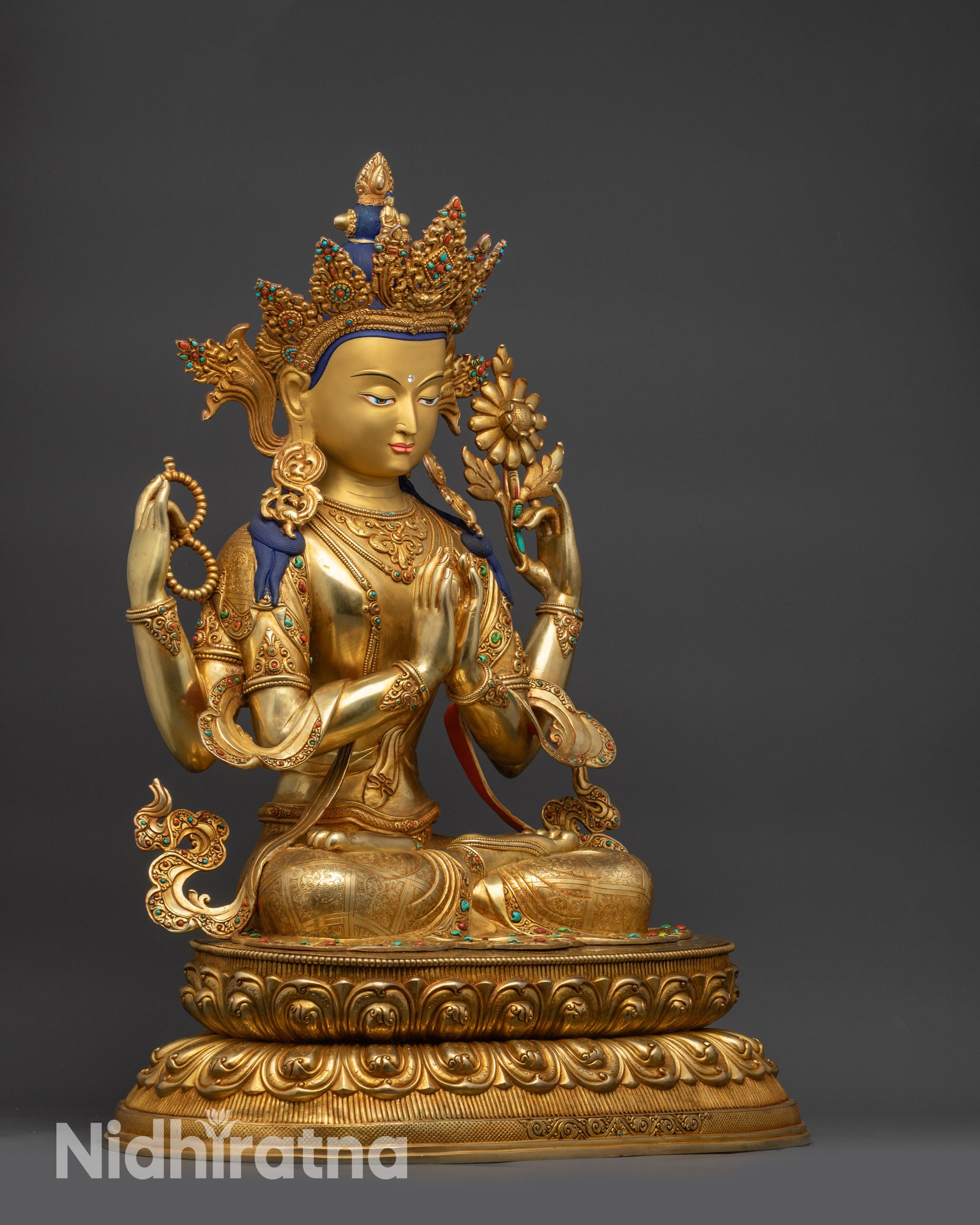 Left view side Chenrezig statue holding wish-fulfilling jewel and lotus flower