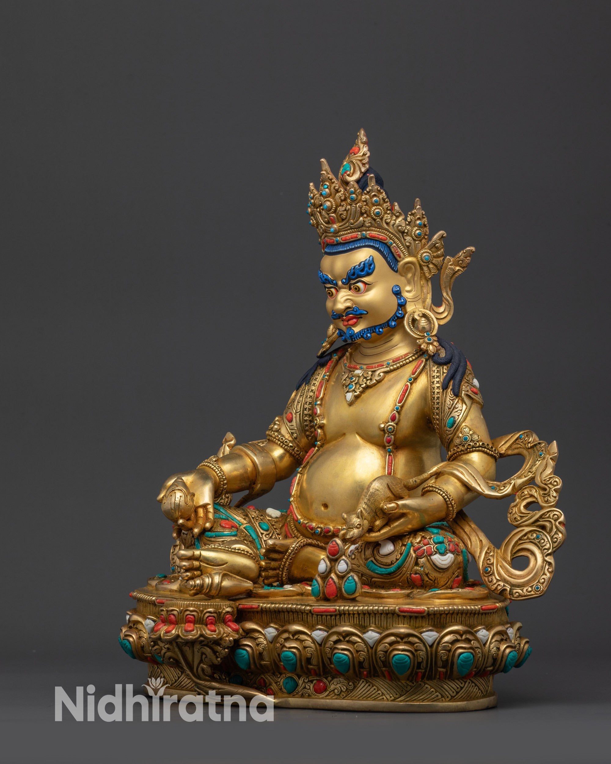 Left view side Dzambhala Statue showing elaborate garments and intricate carved patterns