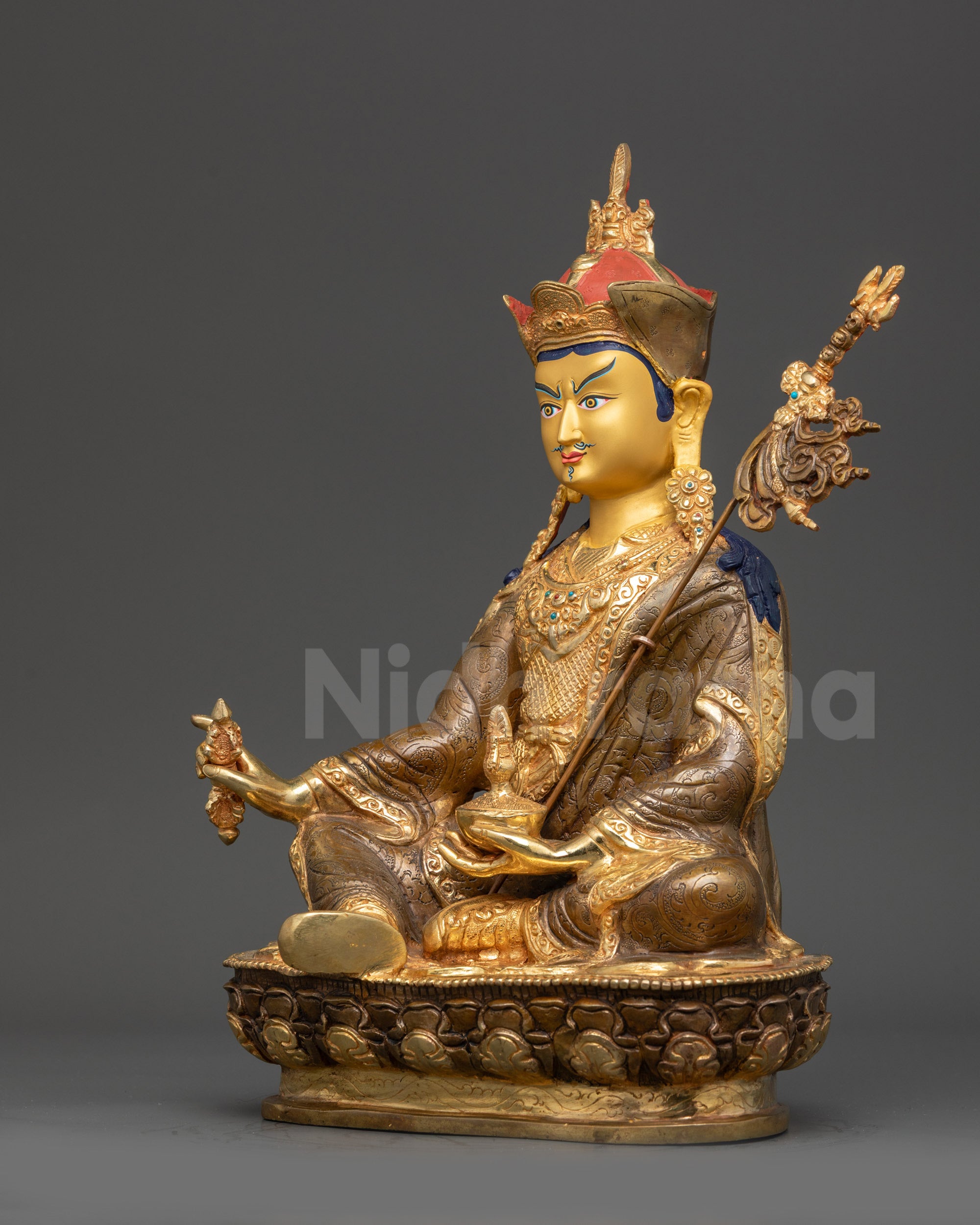 Left view side Guru Padmasambhava statue showing swirling robe and lotus hat details