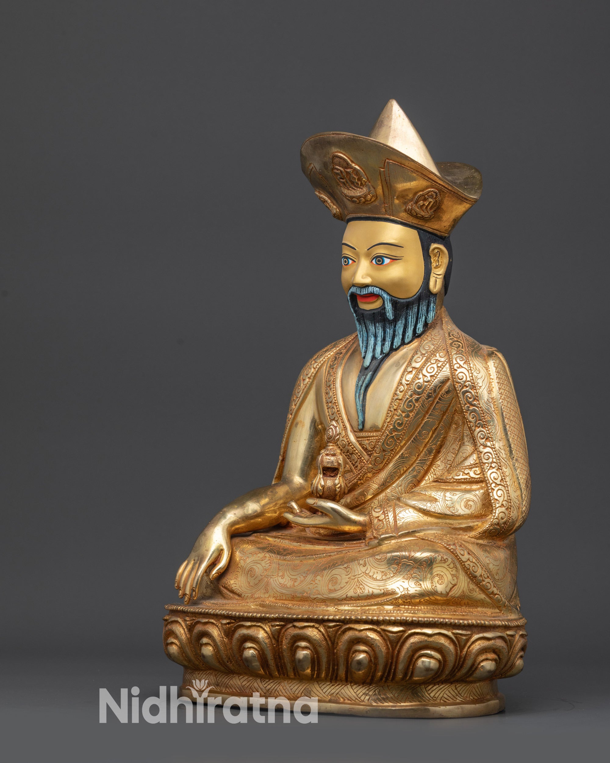 Left view side of Guru Shapdum statue showing carved garments and lotus seat