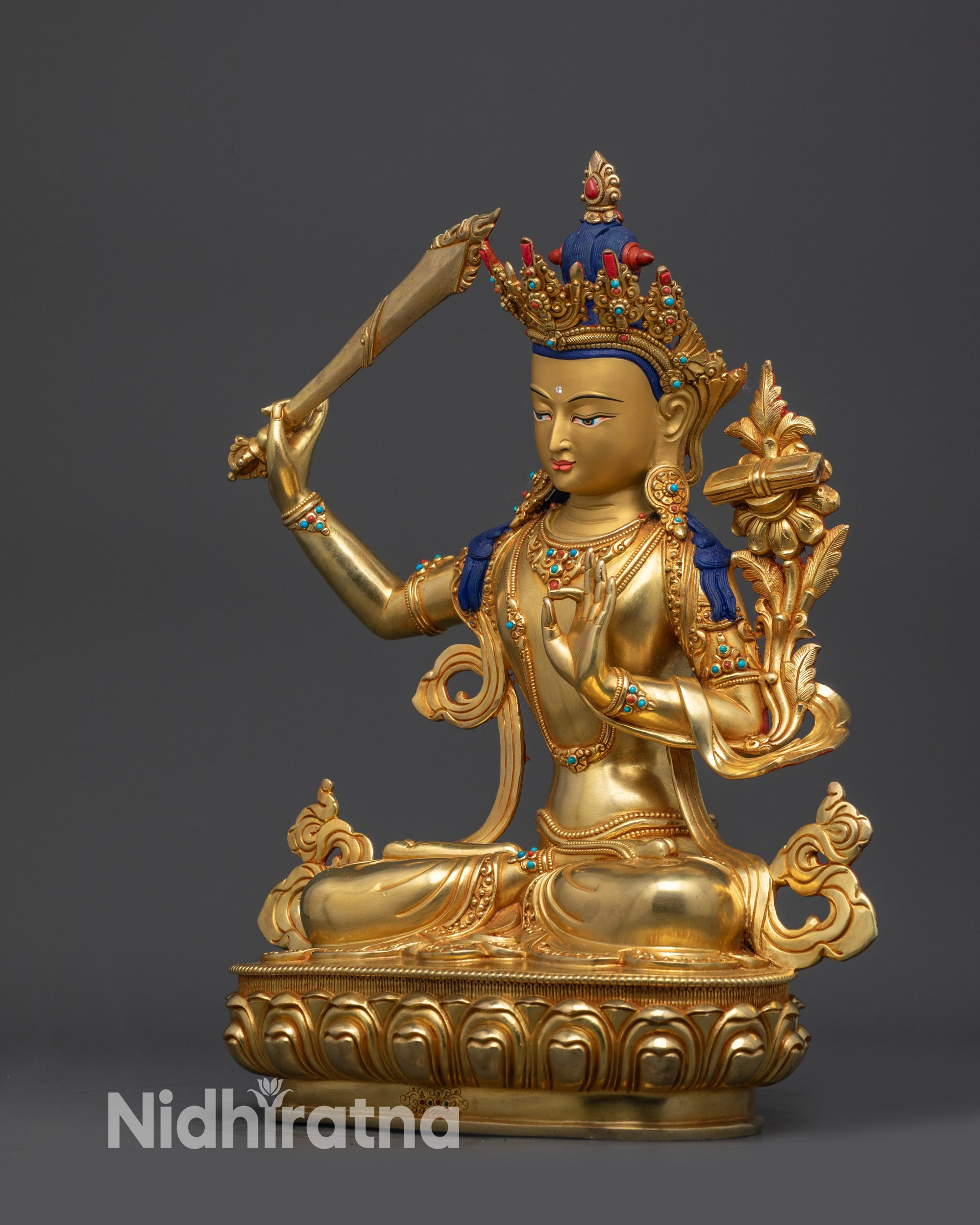 Left view side of Manjushri Bodhisattva statue showing swirling robe and gold-gilded face