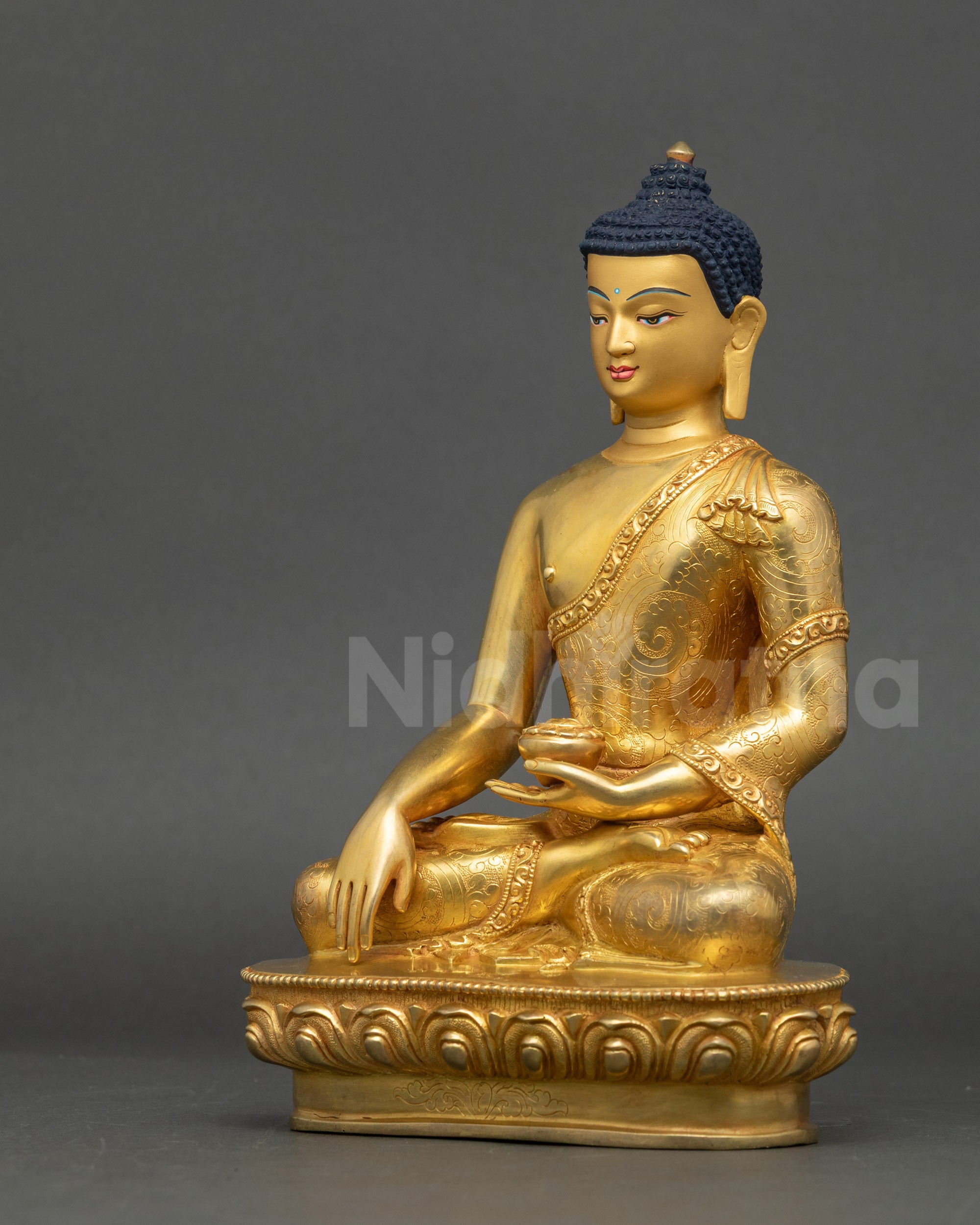 Left view side of Shakyamuni Buddha statue showing lotus seat and intricate robe details