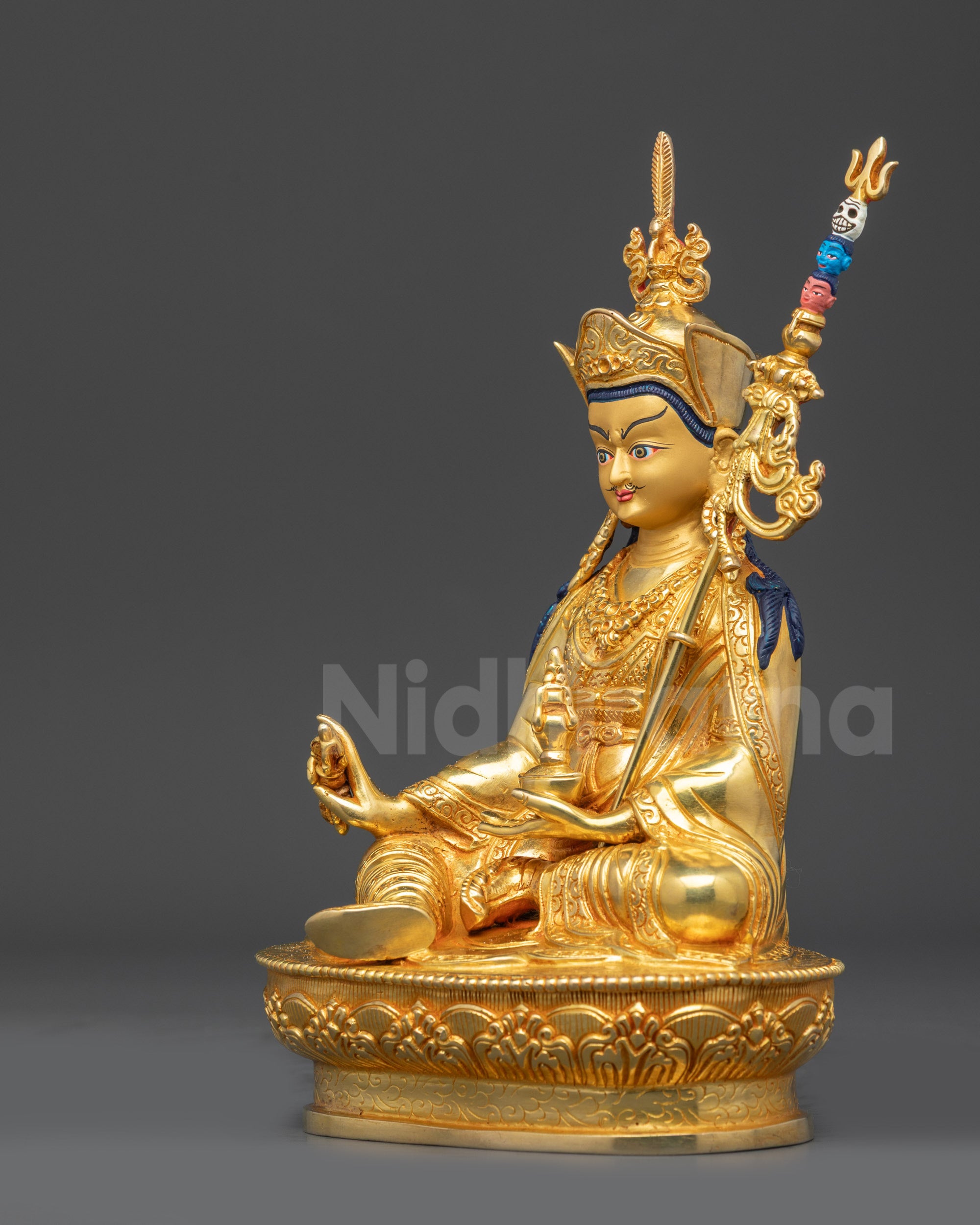 Left view side of gold fire-gilded Guru Padmasambhava seated on lotus throne