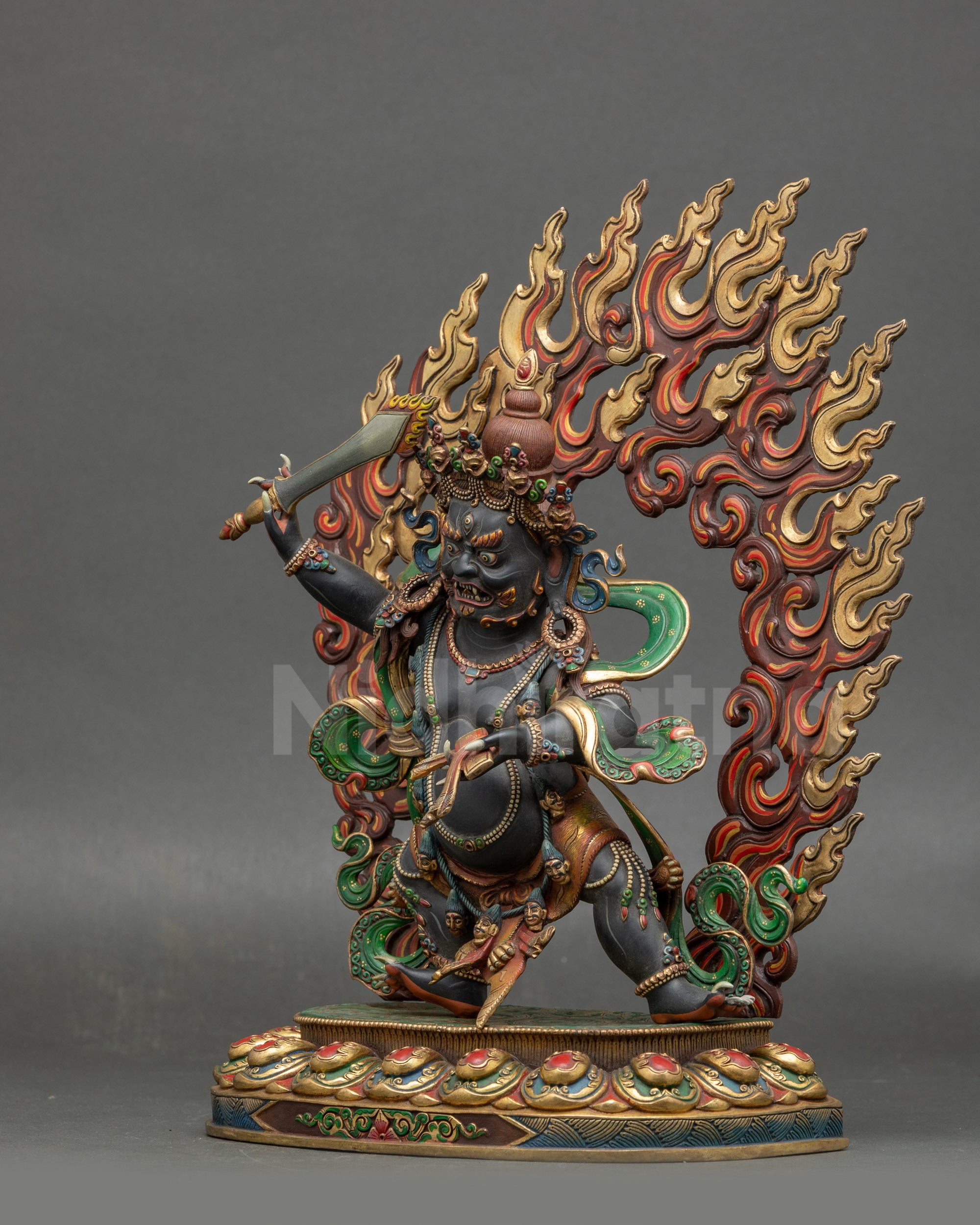 Left view side of wrathful Manjushri statue with skulls garland and gold-plated accents