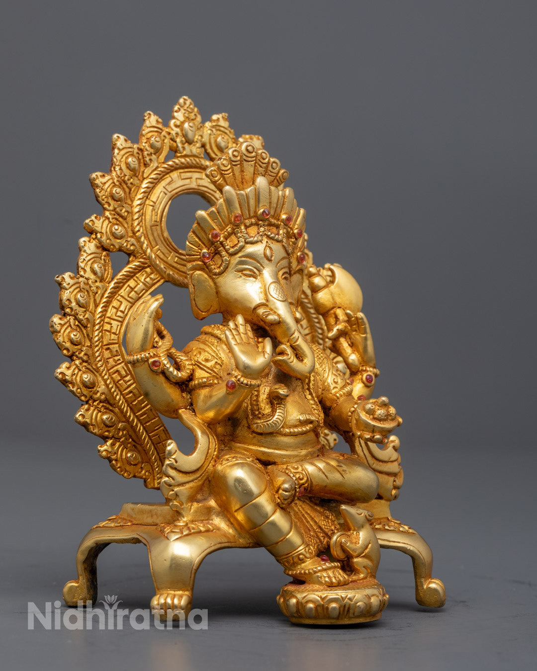 Lord Ganesha holding axe, mala, and sweet bowl on ornate throne with floral carvings – sacred Hindu statue for spiritual growth