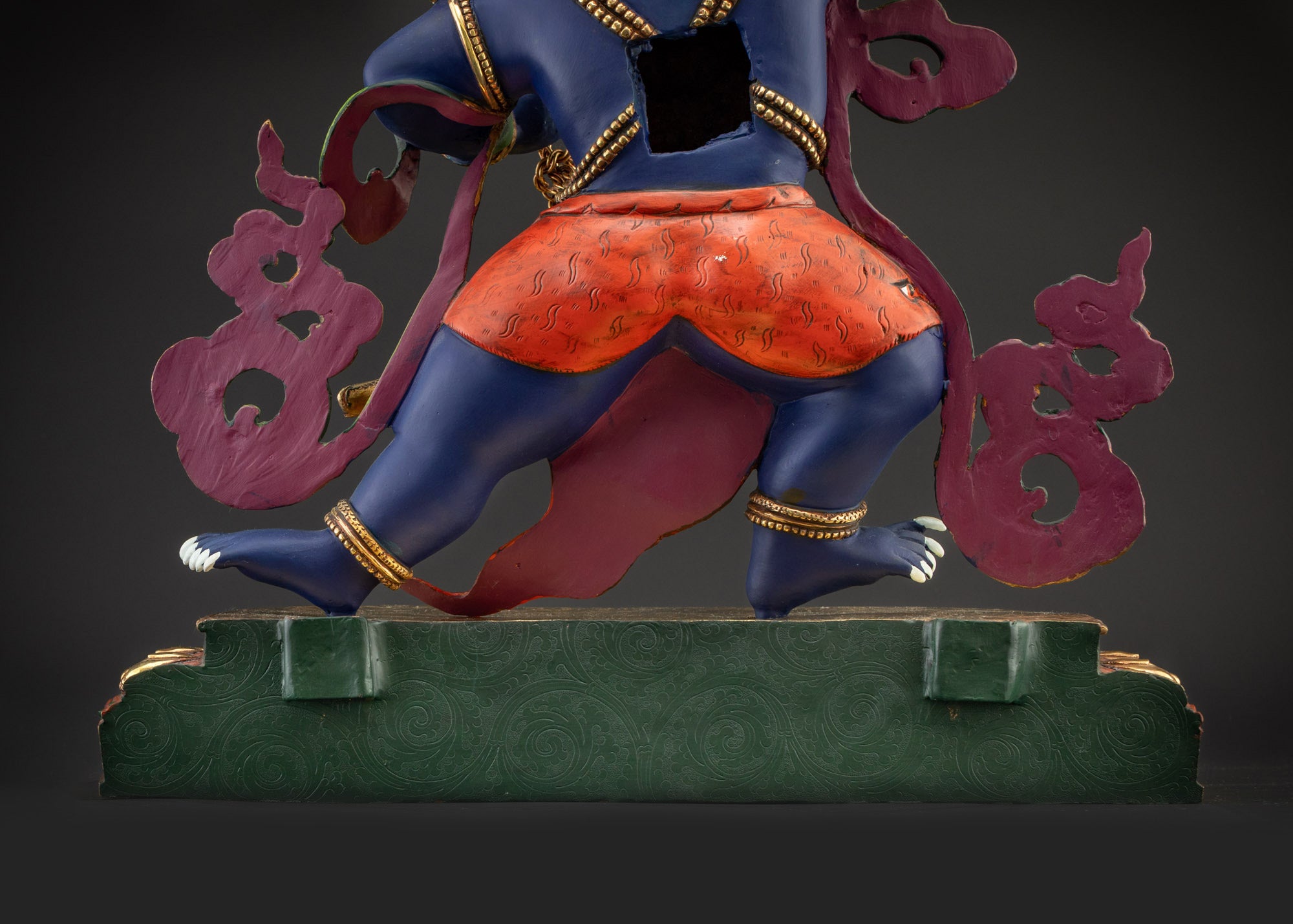 Lower landscape back view Vajrapani statue showing full multicolored halo