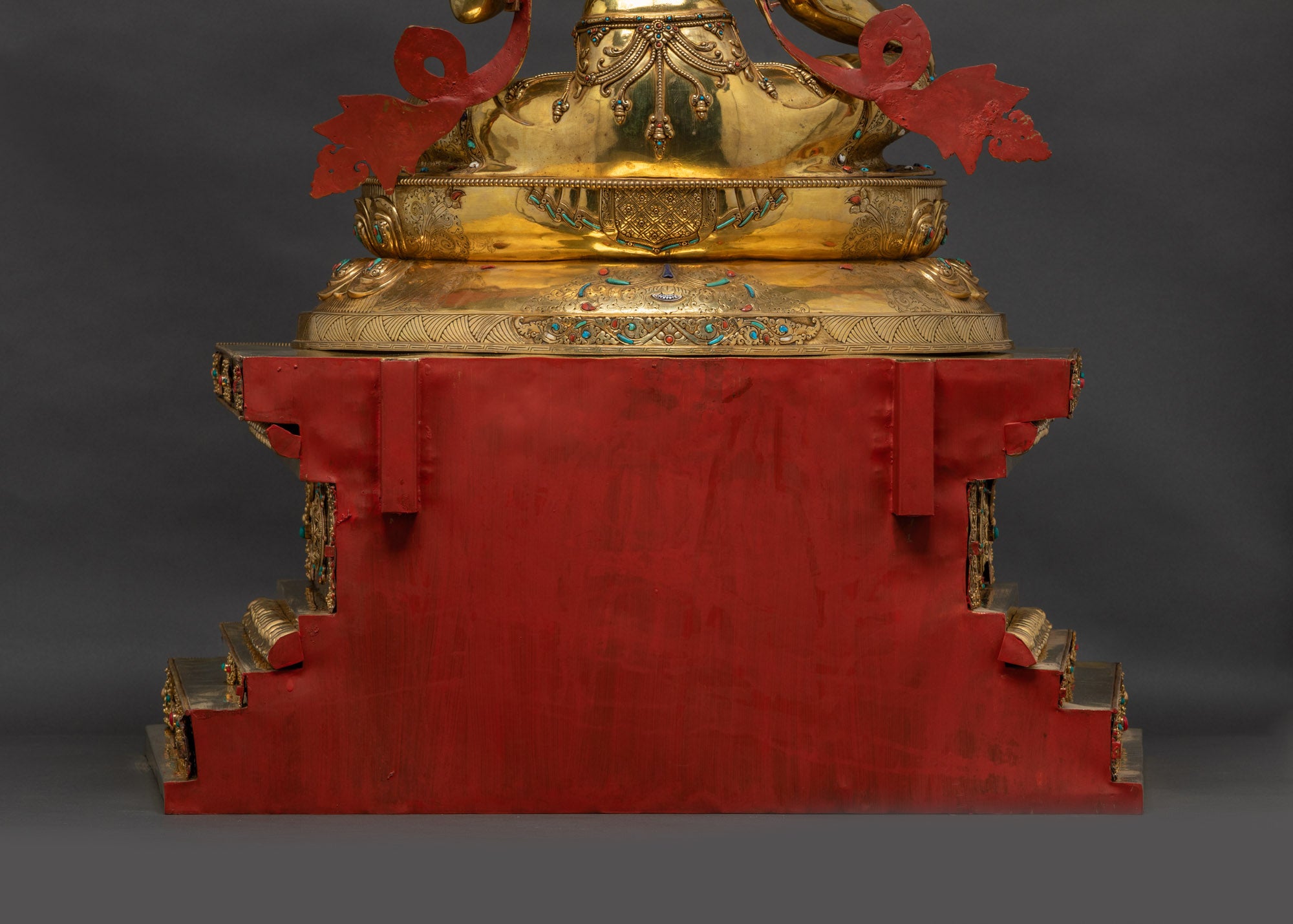 Lower landscape shot back of Green Tara Statue highlighting halo and detailed throne