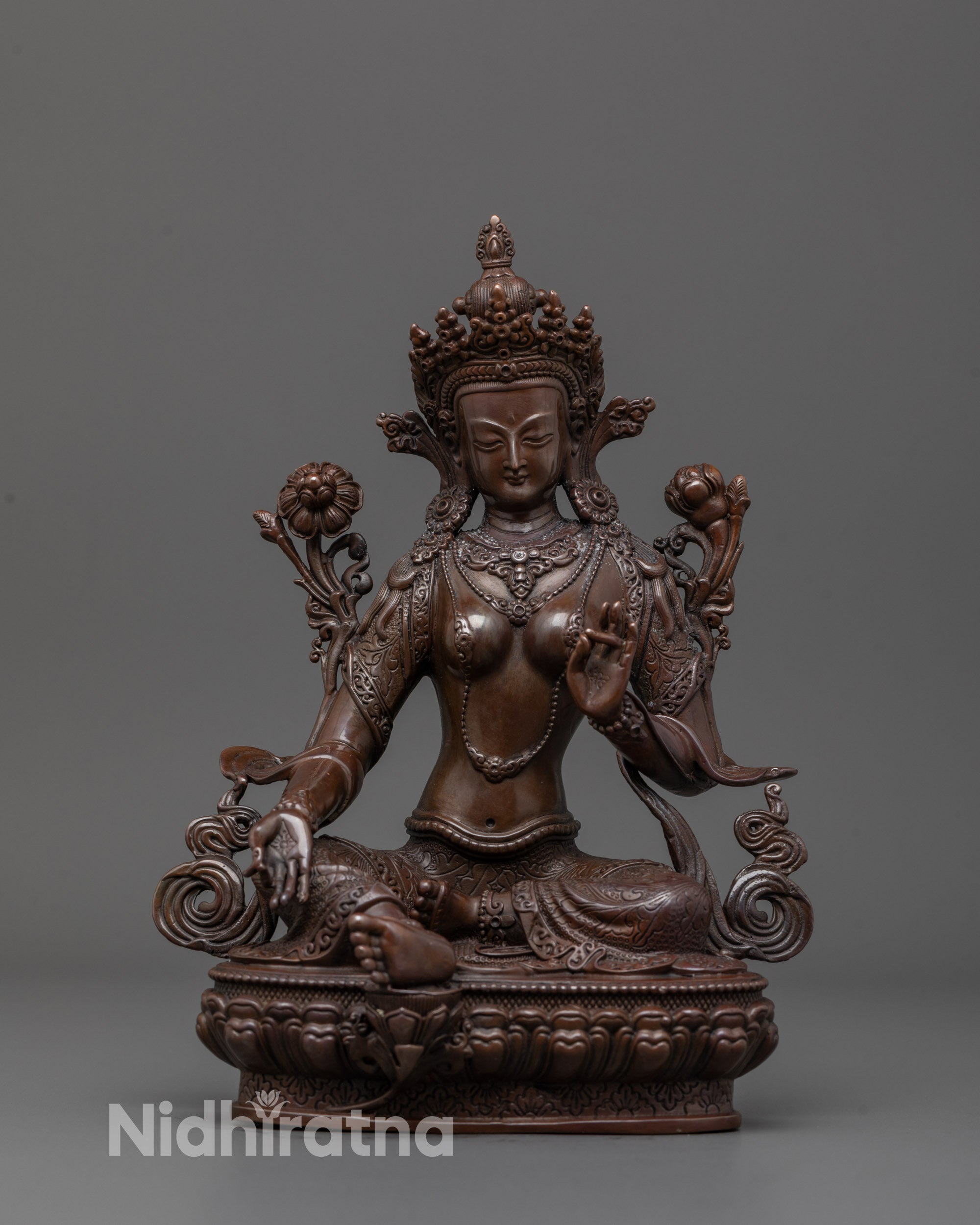 Machine-made Green Tara Statue seated on lotus base with peaceful expression