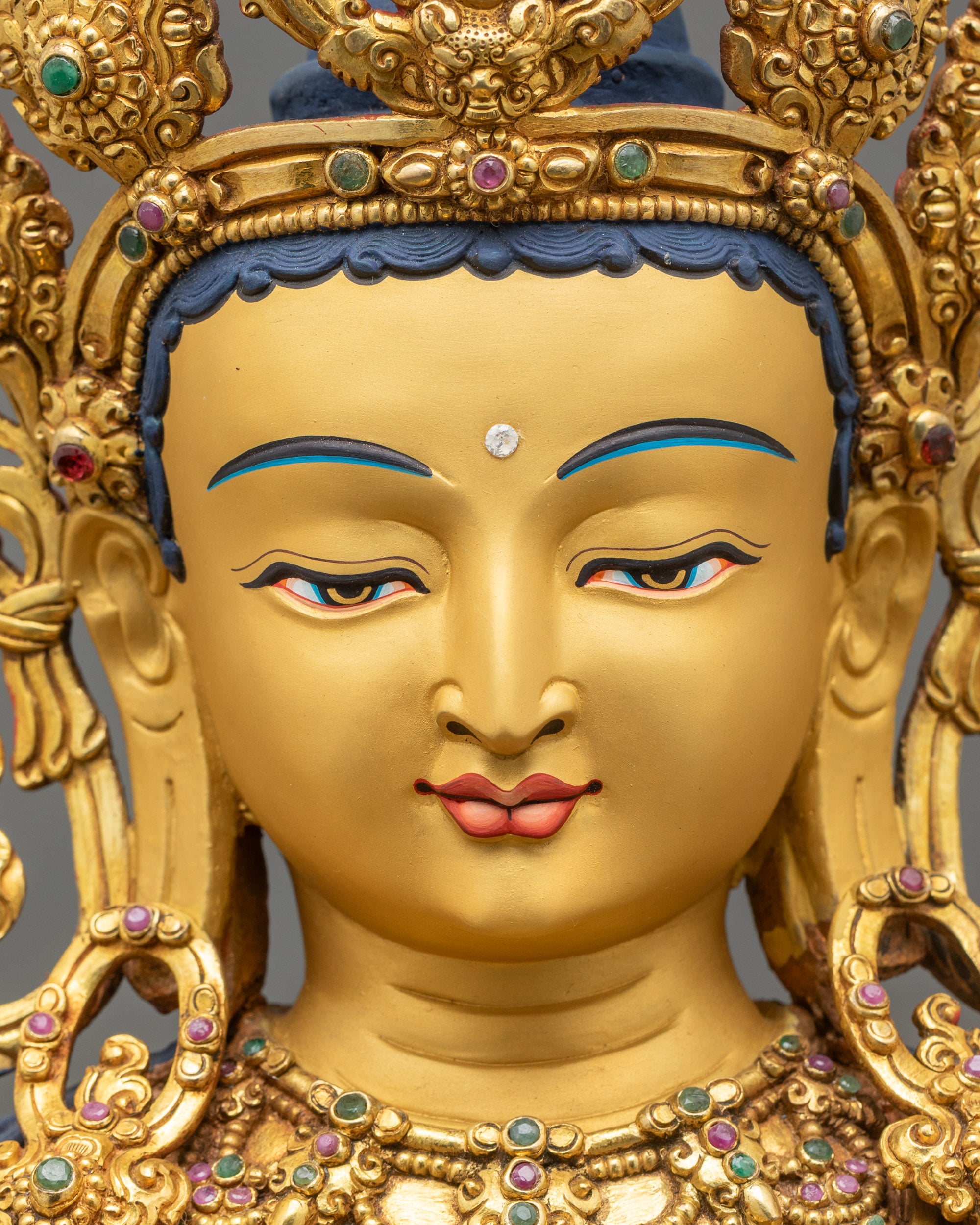 Maitreya Buddha Statue face with 24K gold-painted skin, serene expression, and jeweled crown