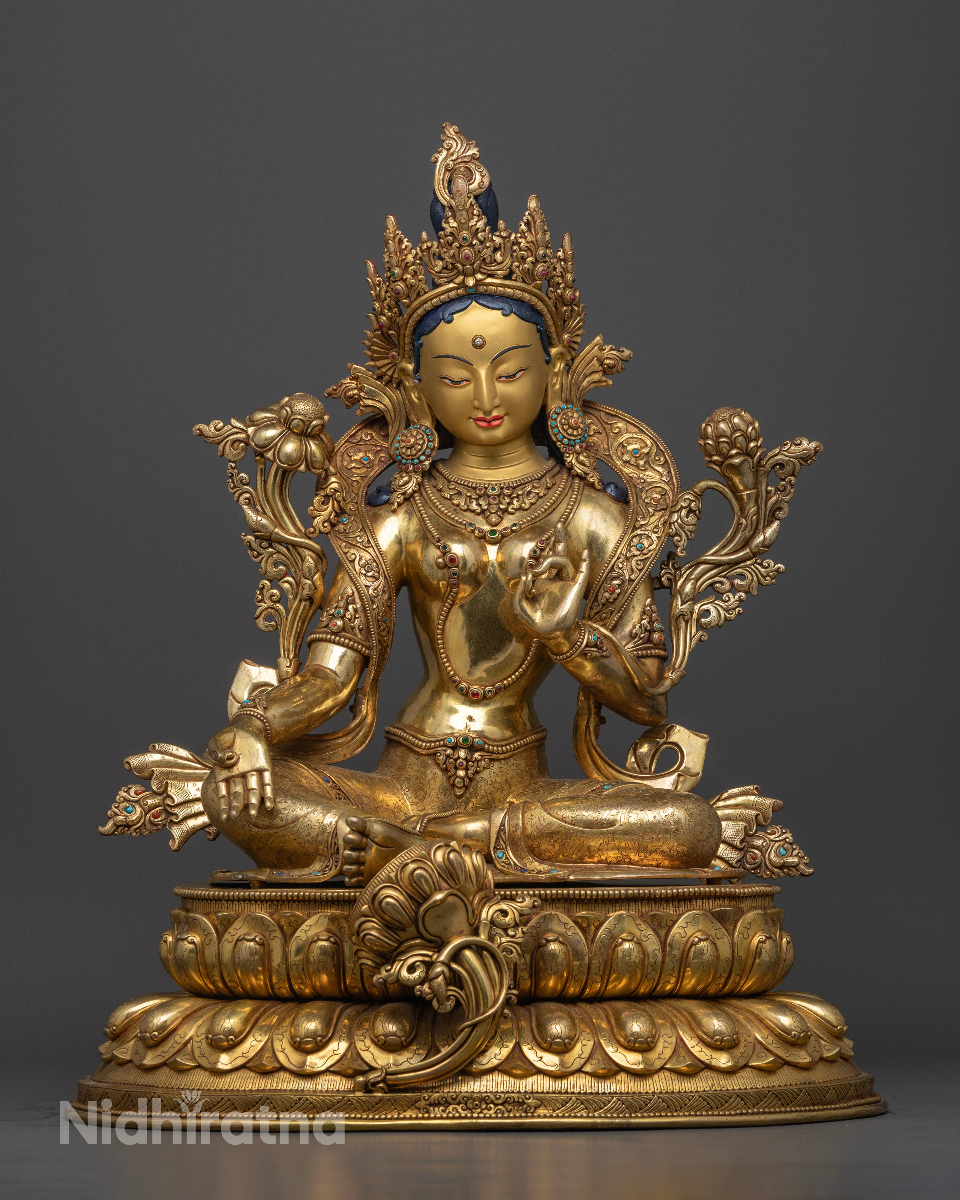 Majestic 52.5cm tall Green Tara statue handcrafted in Patan, Nepal, featuring a 24k gold-plated face, vibrant acrylic colors, and semi-precious stone adornments.