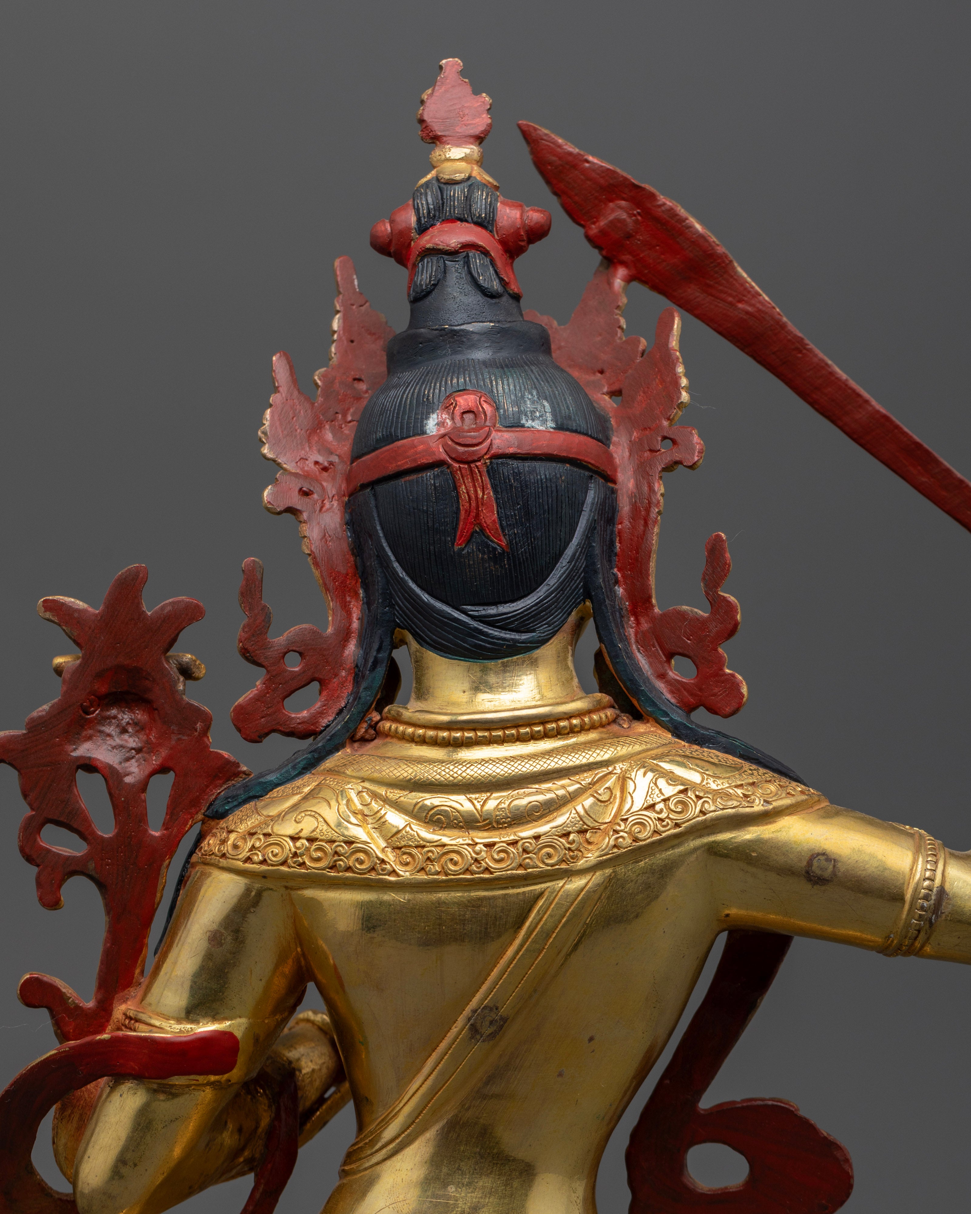 The back profile of manjushree statue's with the hairs painted black with acrylic colour | Handcrafted Manjushree statue | Sword of wisdom Manjushree statue