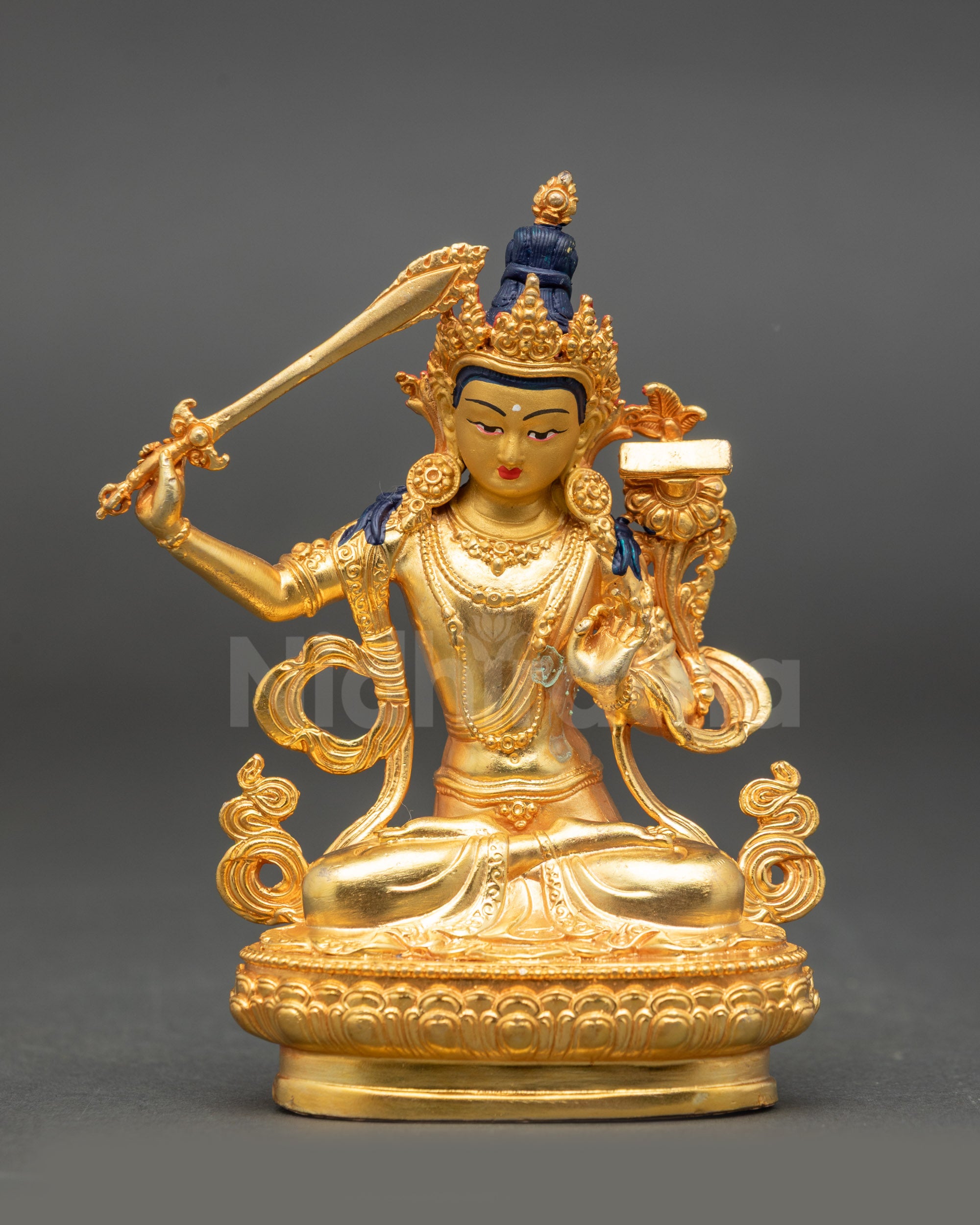 Manjushri Statue front view gold fire-gilded face seated on lotus with sword and lotus flower