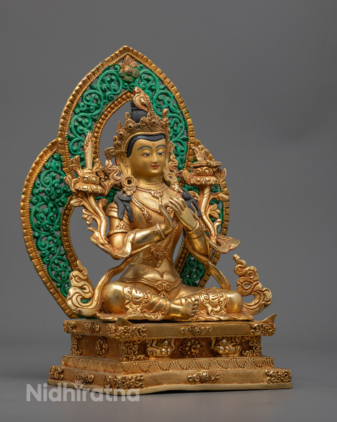Manjushri Tibetan Buddhist figure seated on lotus throne surrounded by Utpala flowers symbolizing purity