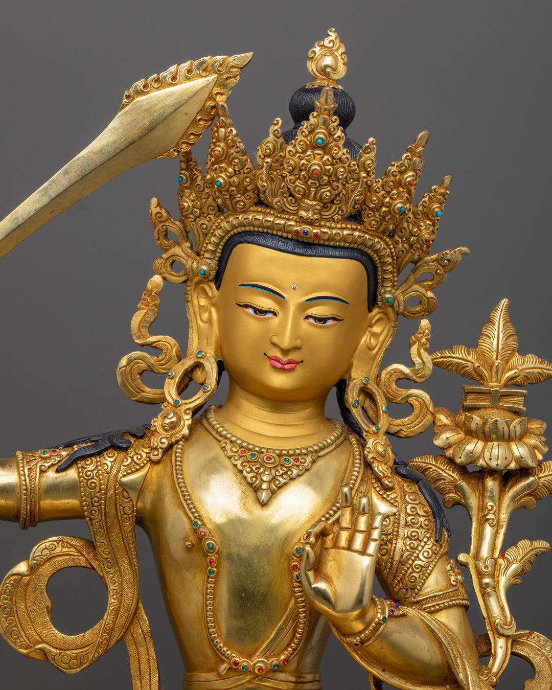 Manjushri’s serene face and lotus throne details